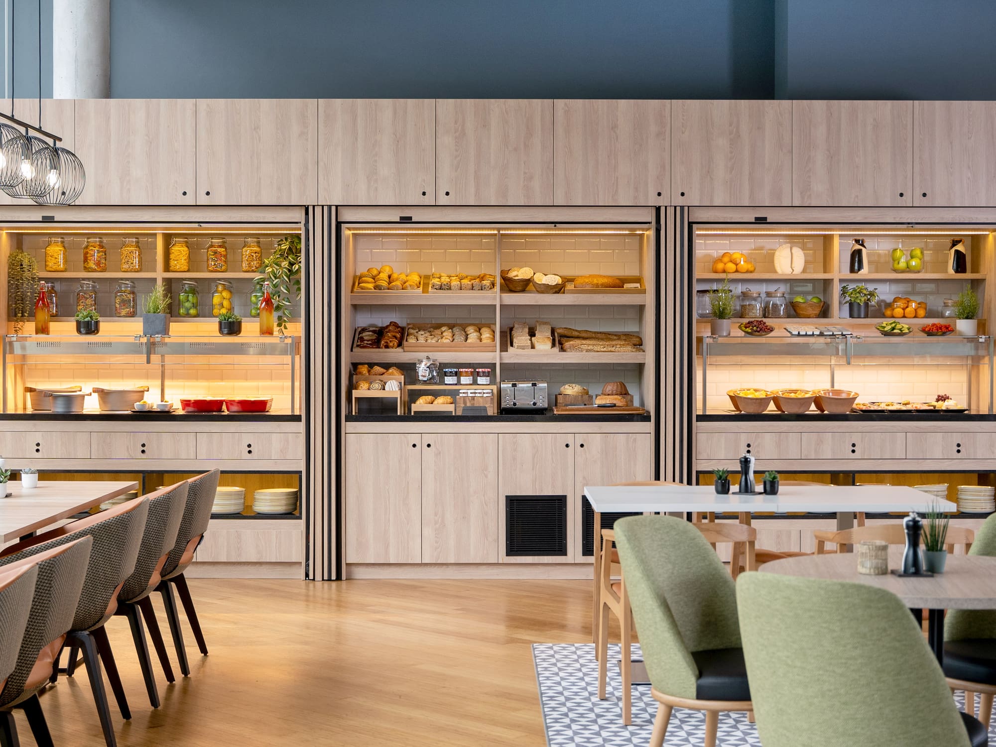 a room with a table and chairs and a display case