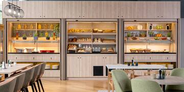 a room with a table and chairs and a display case