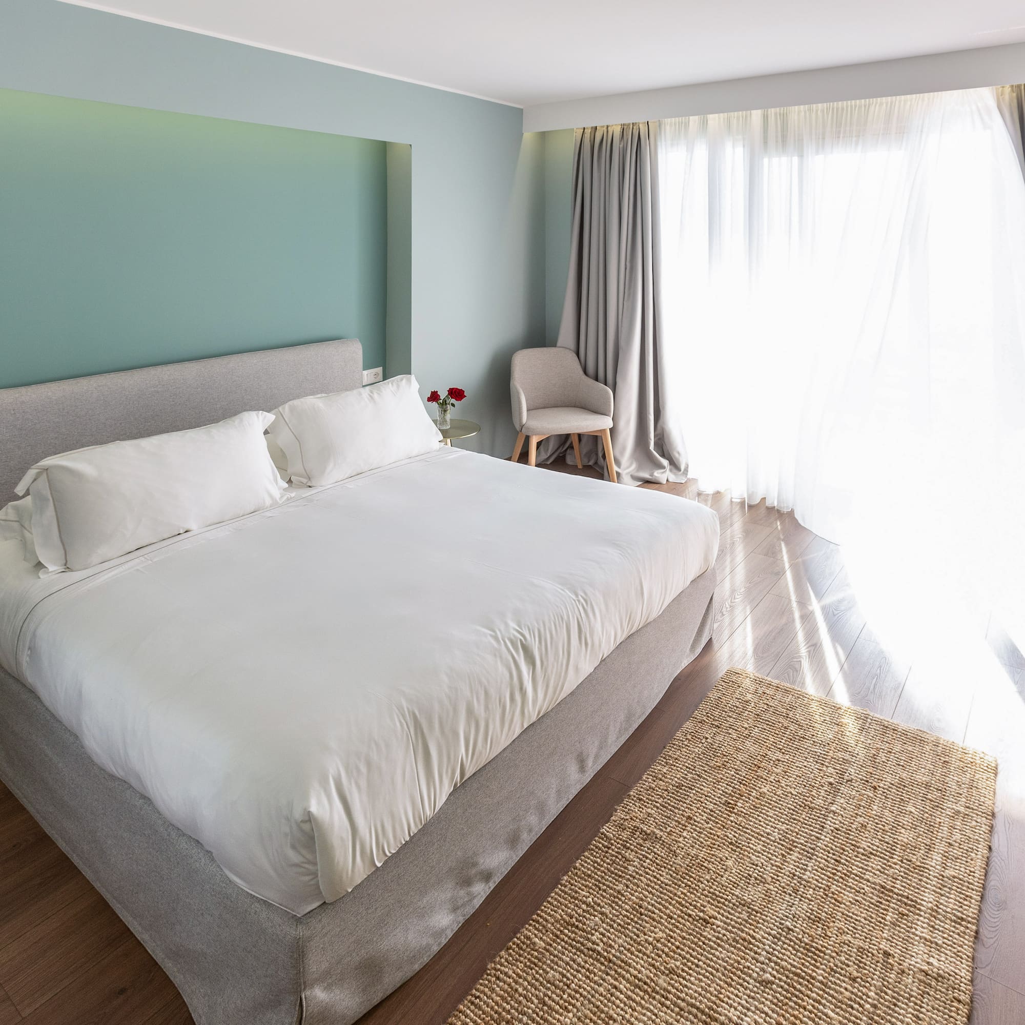 a bedroom with a bed and a chair