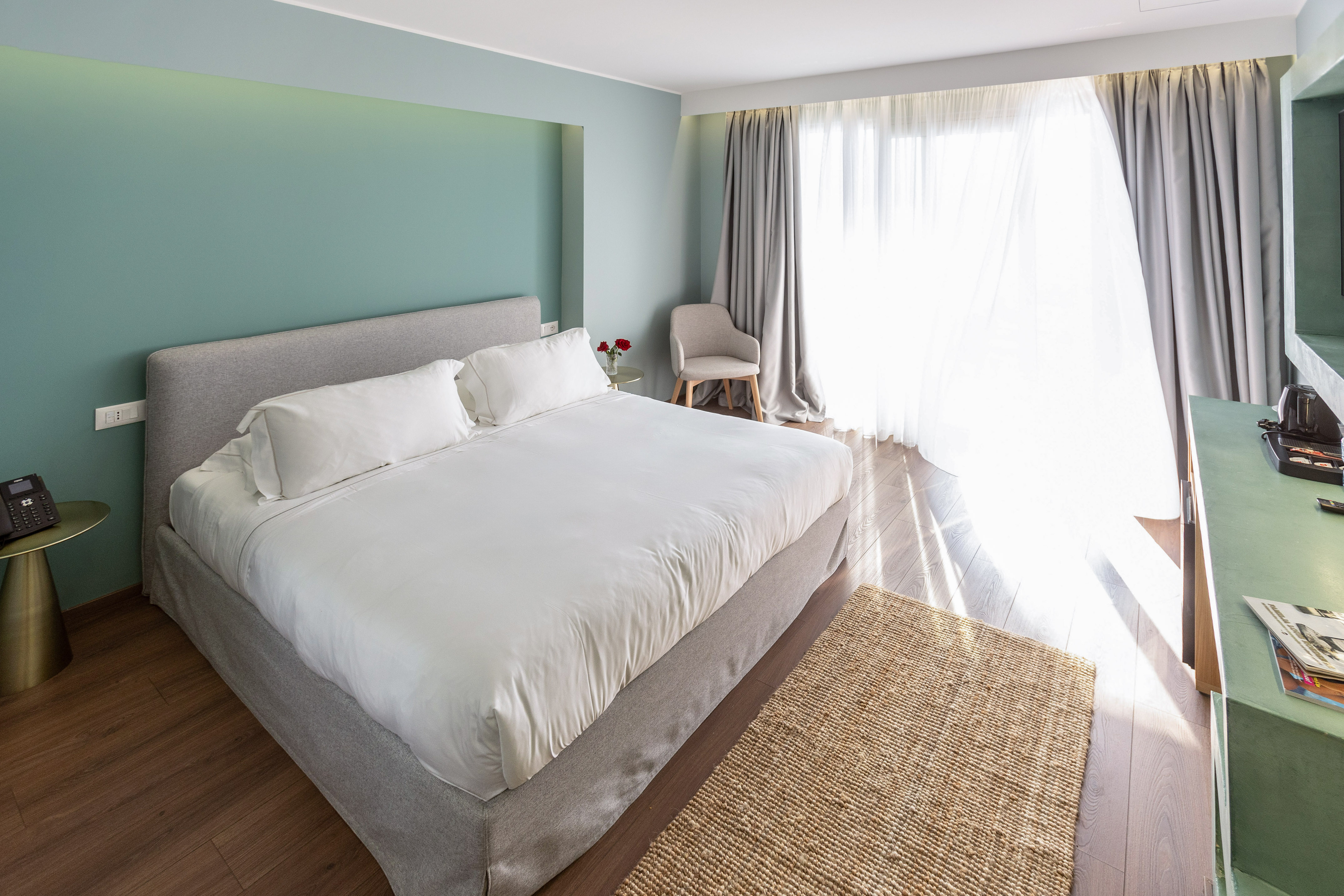 a bedroom with a bed and a chair