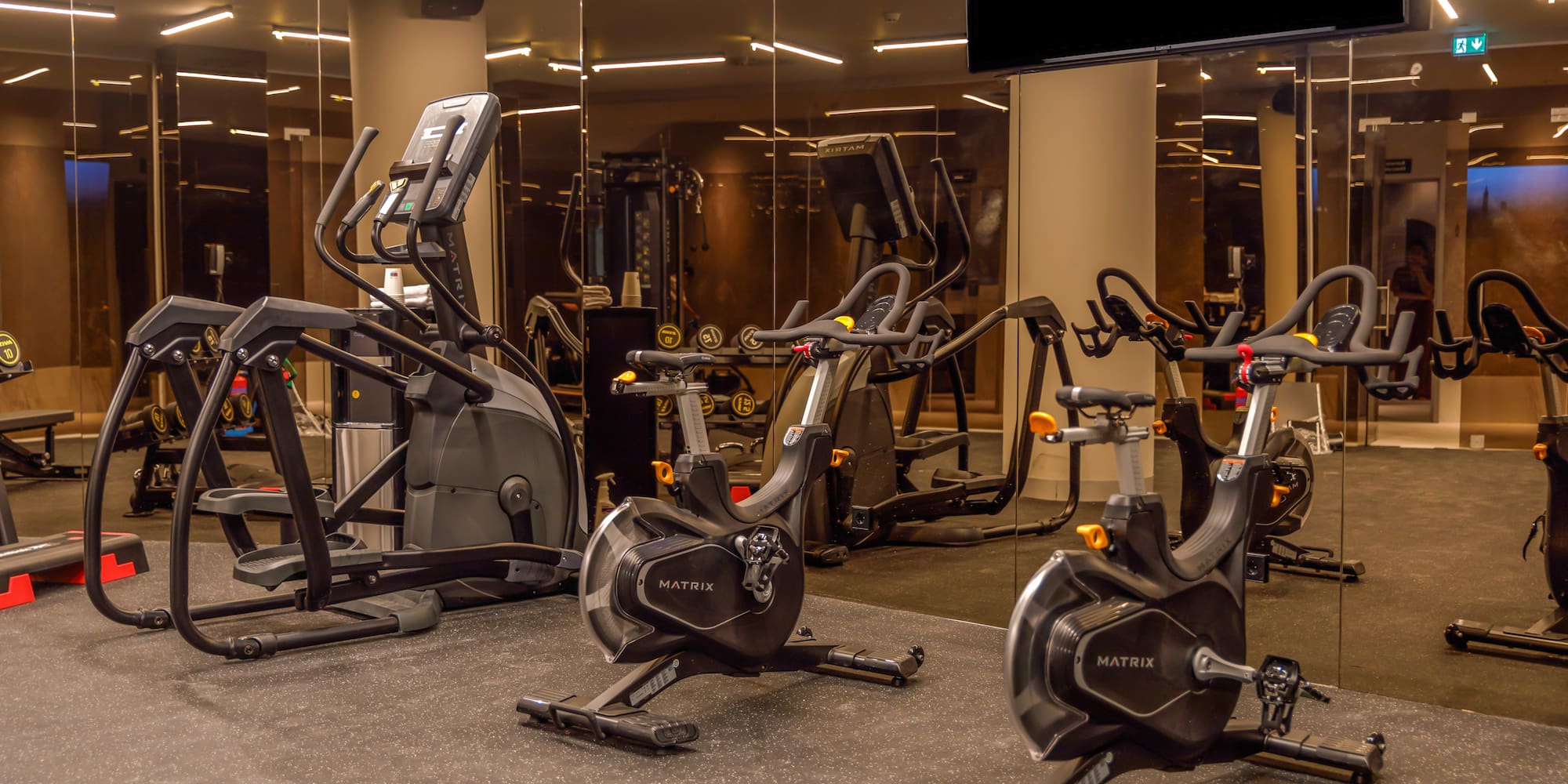 a group of exercise bikes in a gym