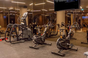 a group of exercise bikes in a gym
