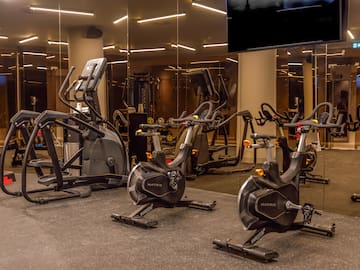 a group of exercise bikes in a gym