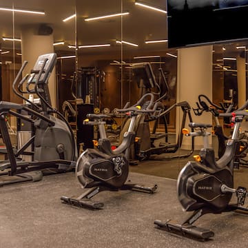 a group of exercise bikes in a gym