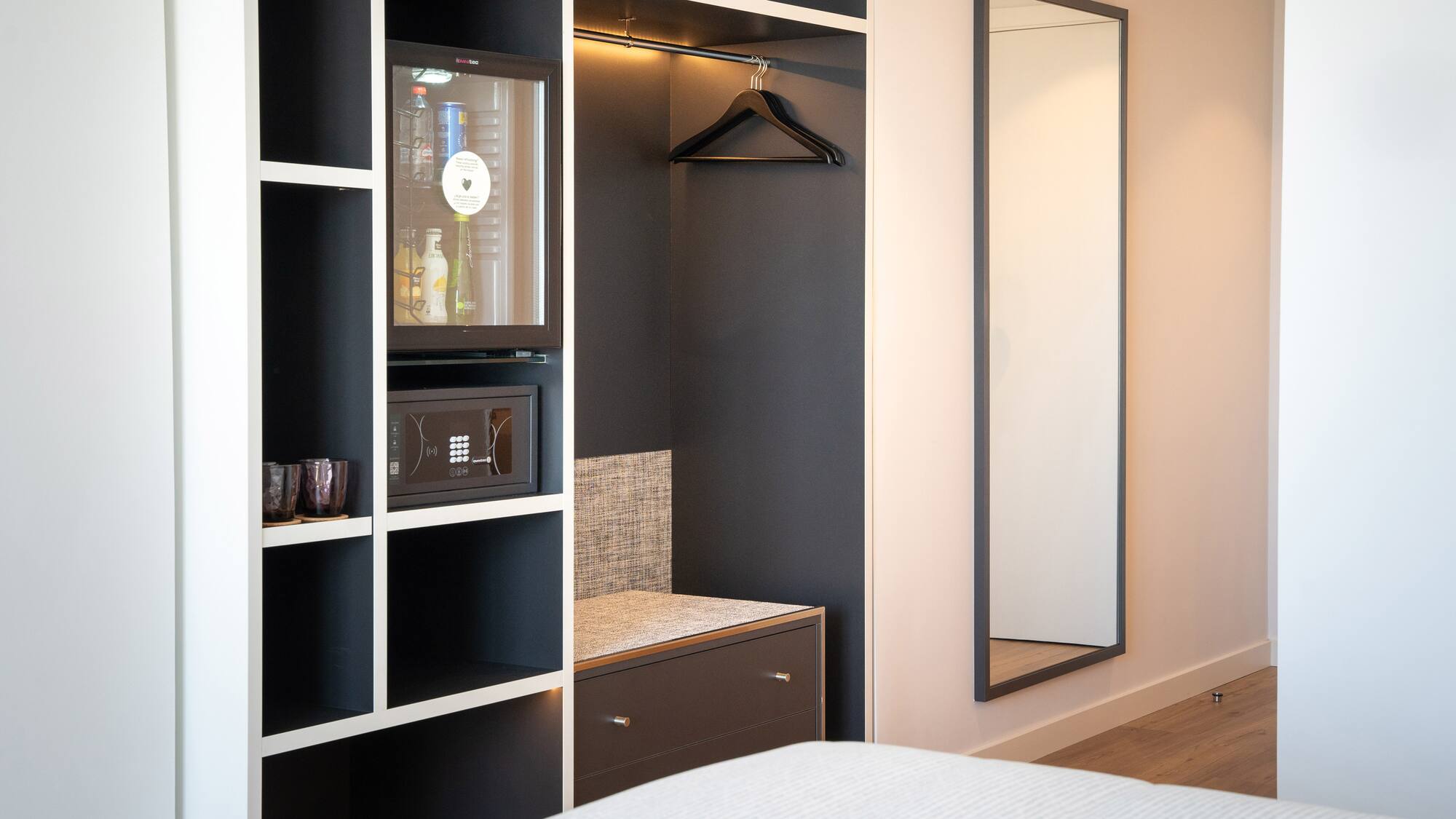 a room with a mirror and a closet