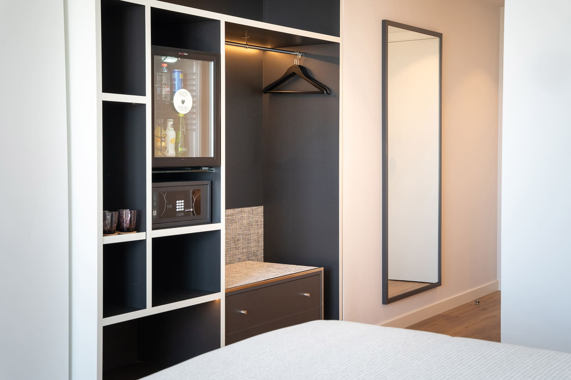 a room with a mirror and a closet