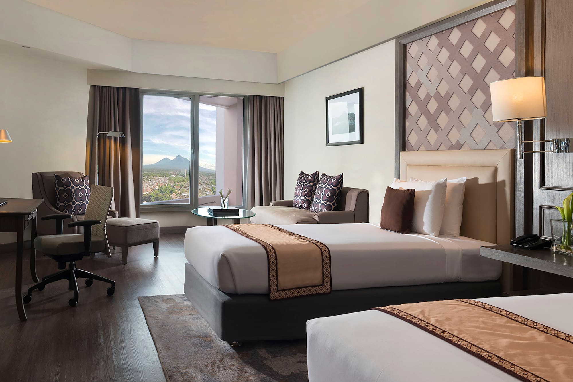 a room with two beds and a window