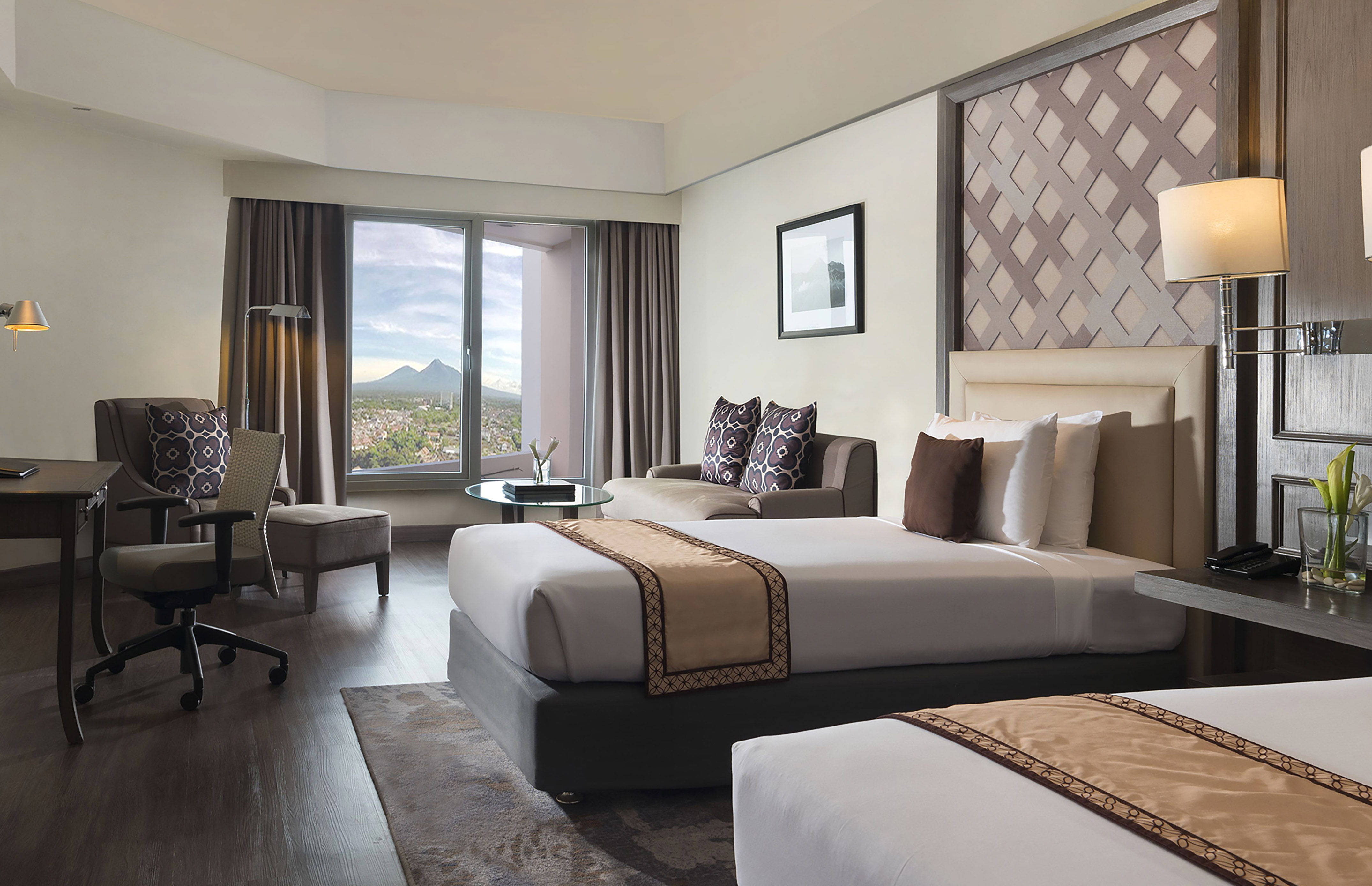 a room with two beds and a window