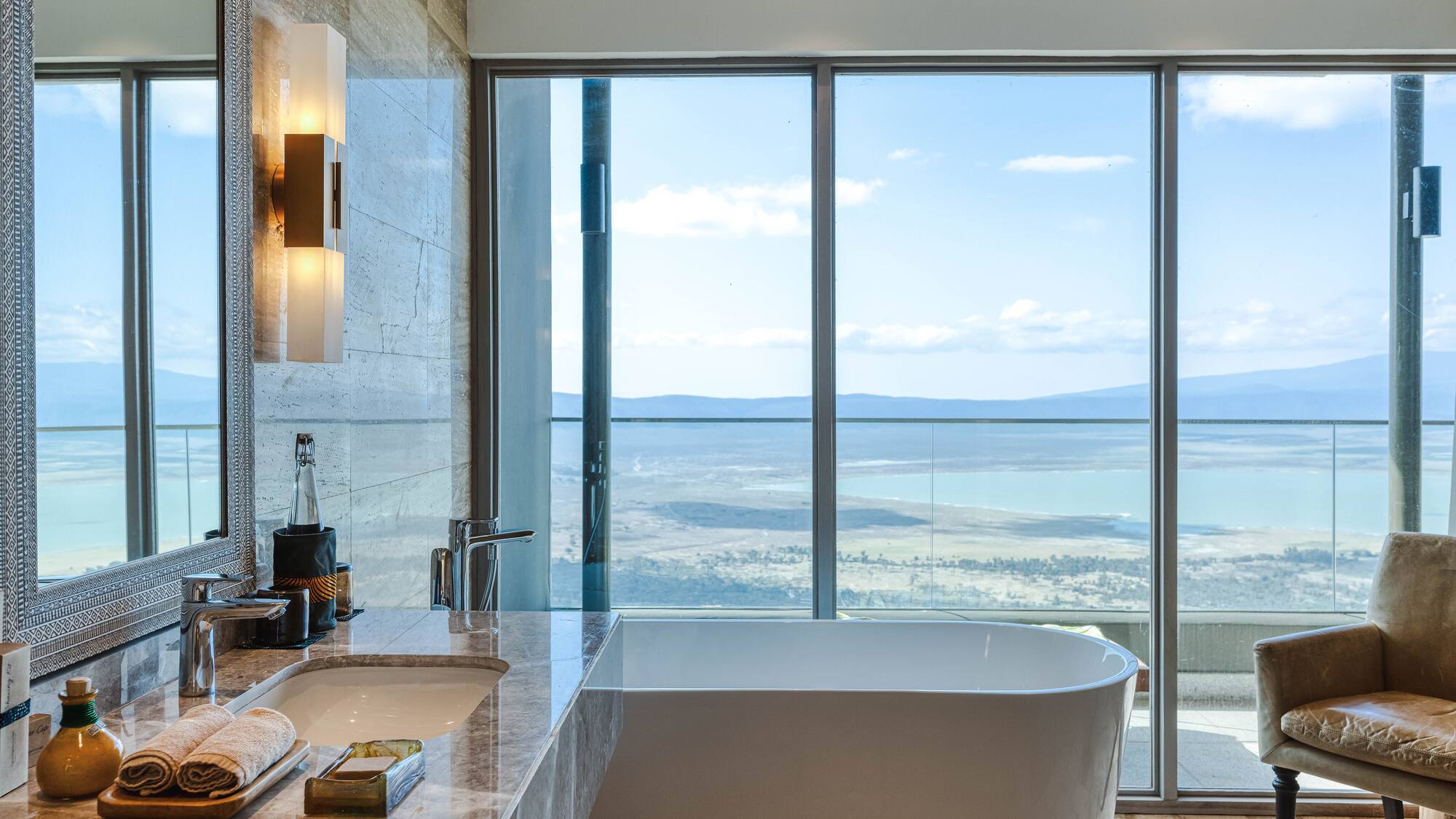 a bathroom with a large window overlooking a lake