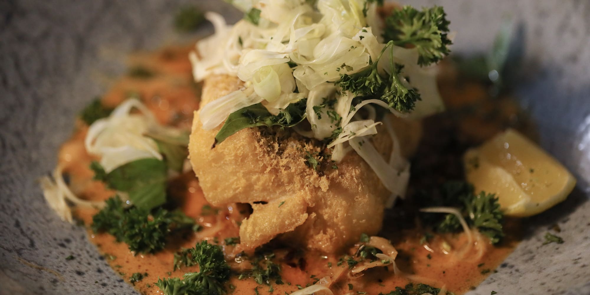 a plate of food with sauce and vegetables