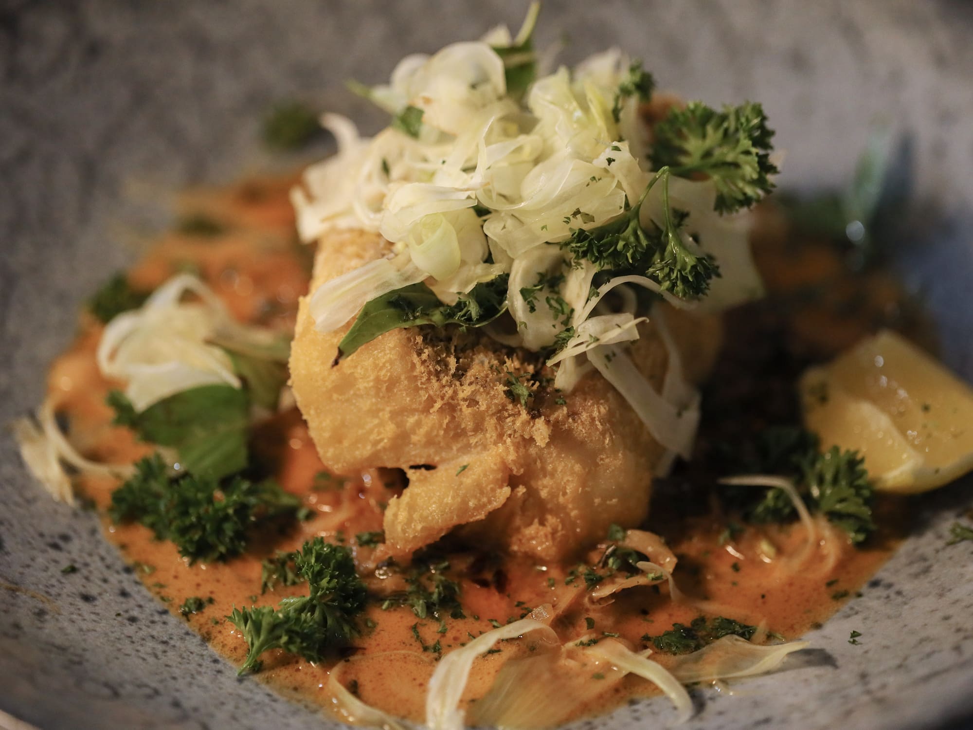 a plate of food with sauce and vegetables