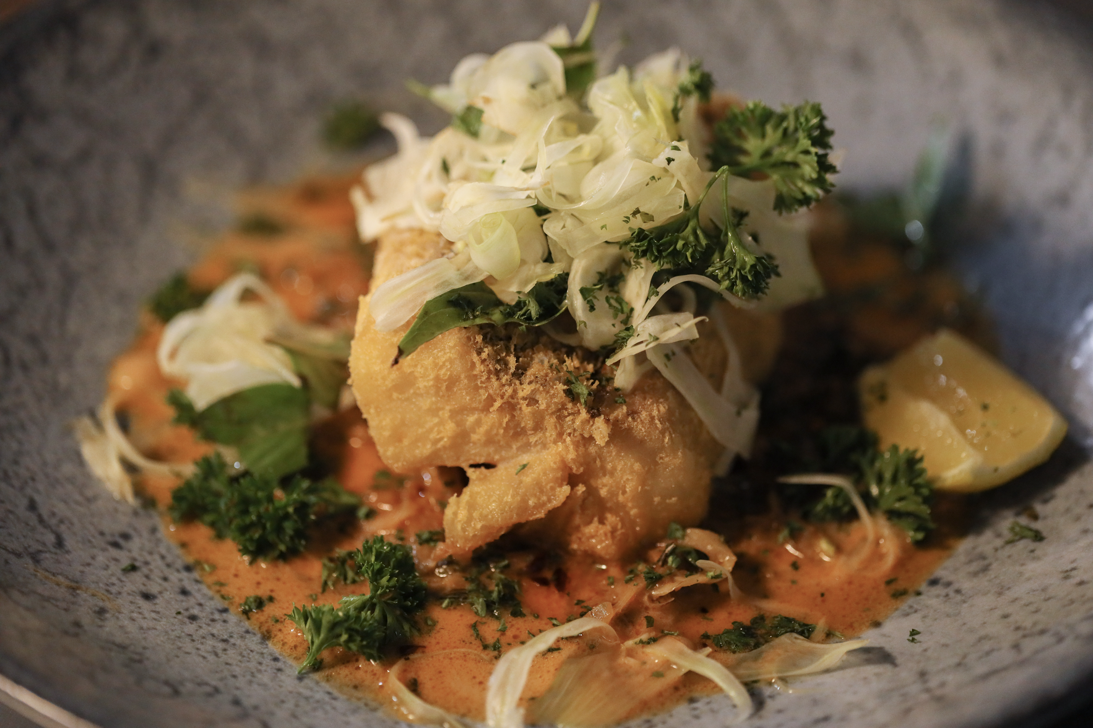 a plate of food with sauce and vegetables