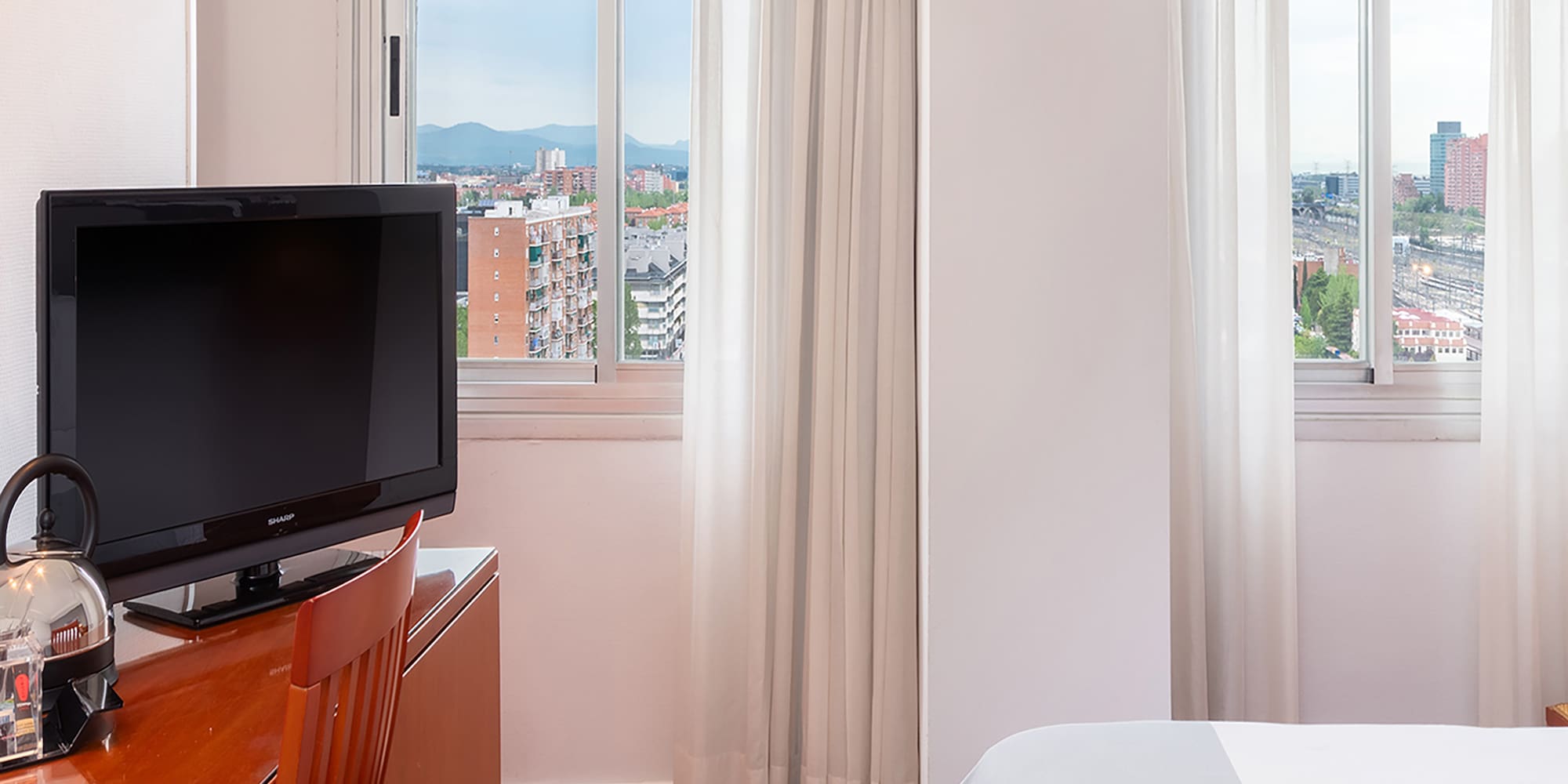 a room with a tv and a desk