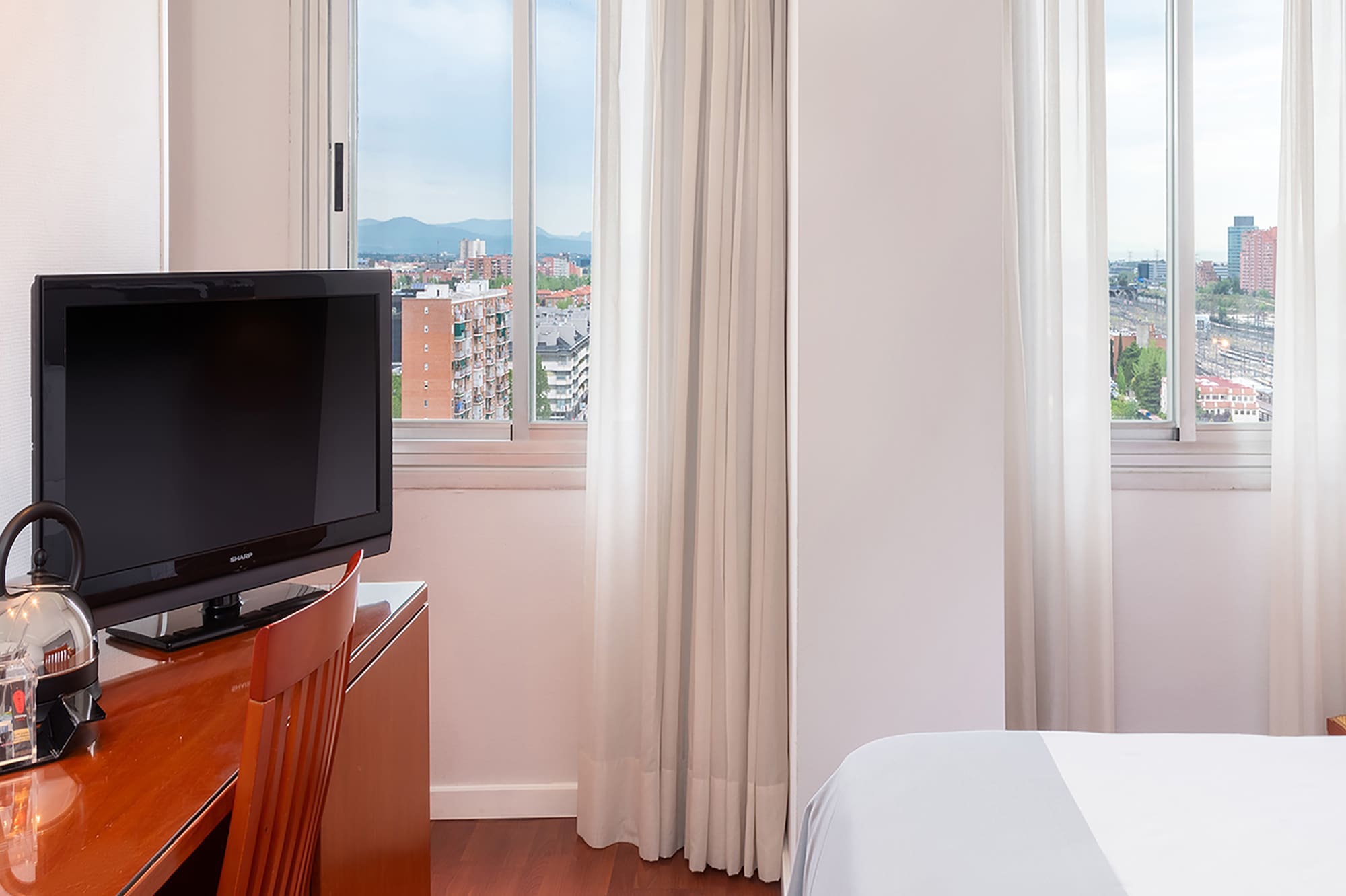 a room with a tv and a desk