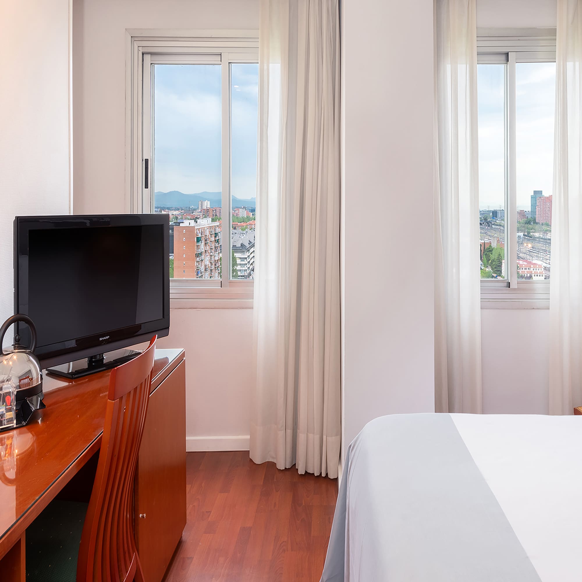 a room with a tv and a desk