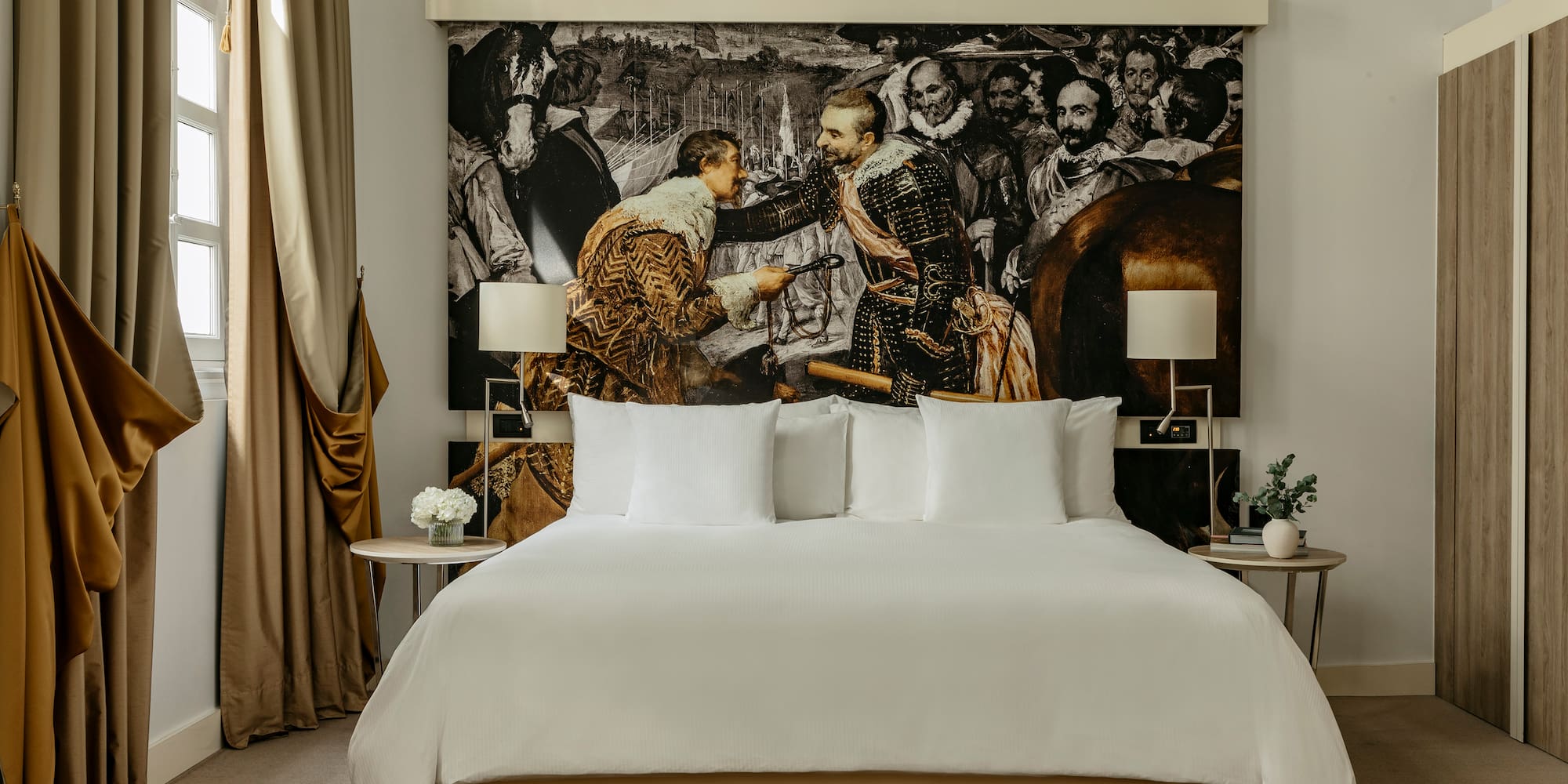 a bed with a picture of men in the background