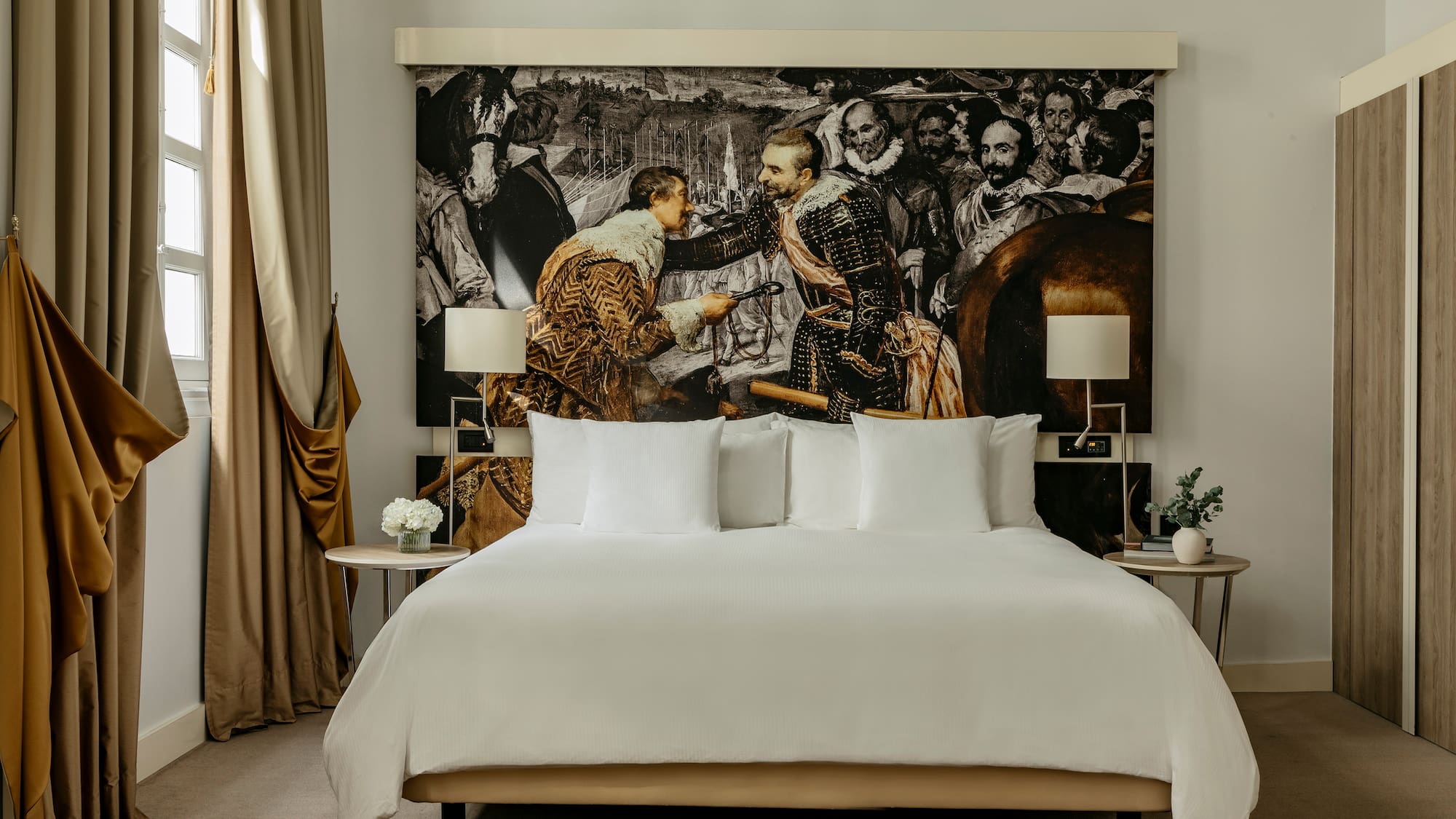 a bed with a picture of men in the background