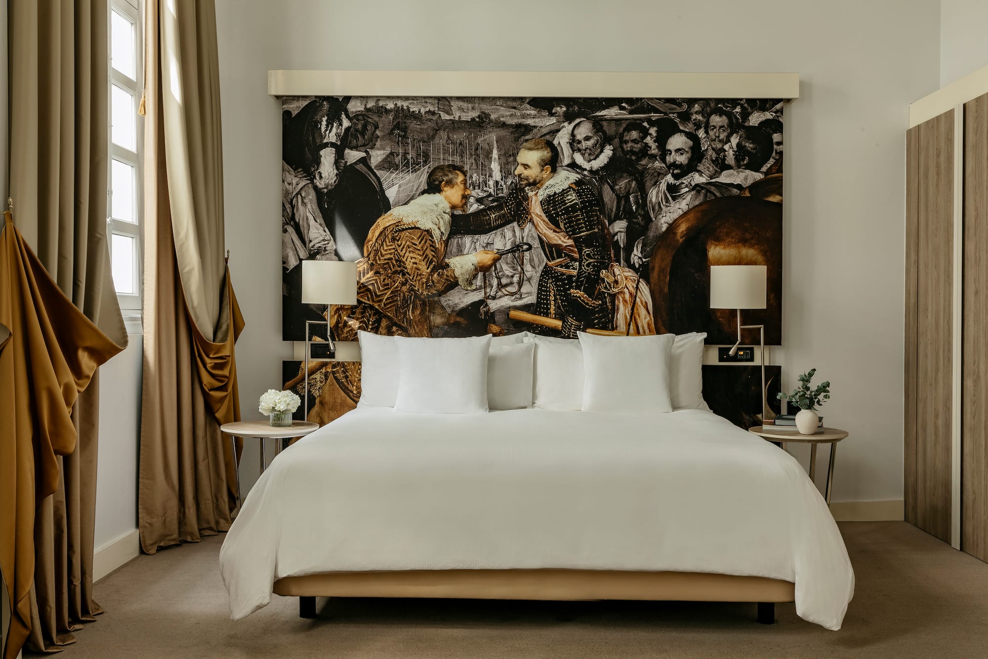 a bed with a picture of men in the background