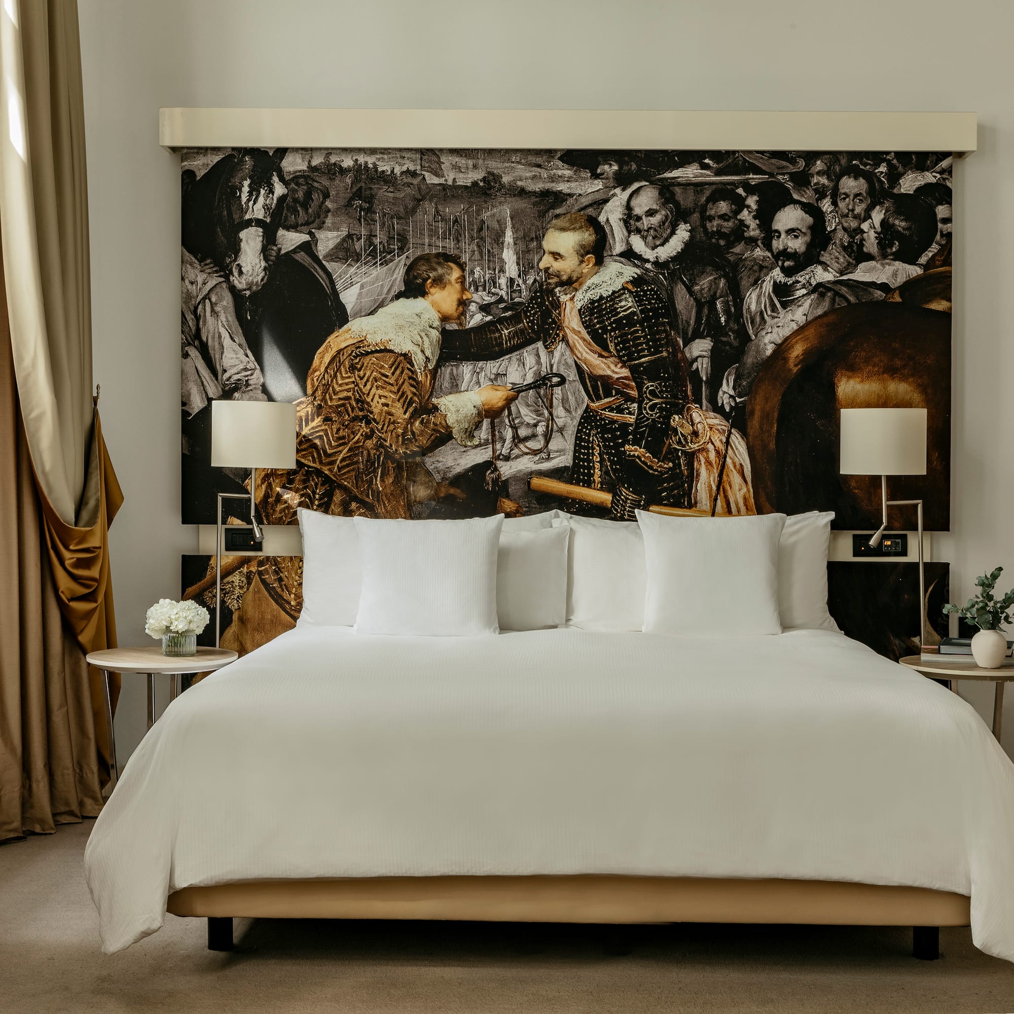 a bed with a picture of men in the background