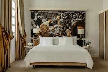 a bed with a picture of men in the background