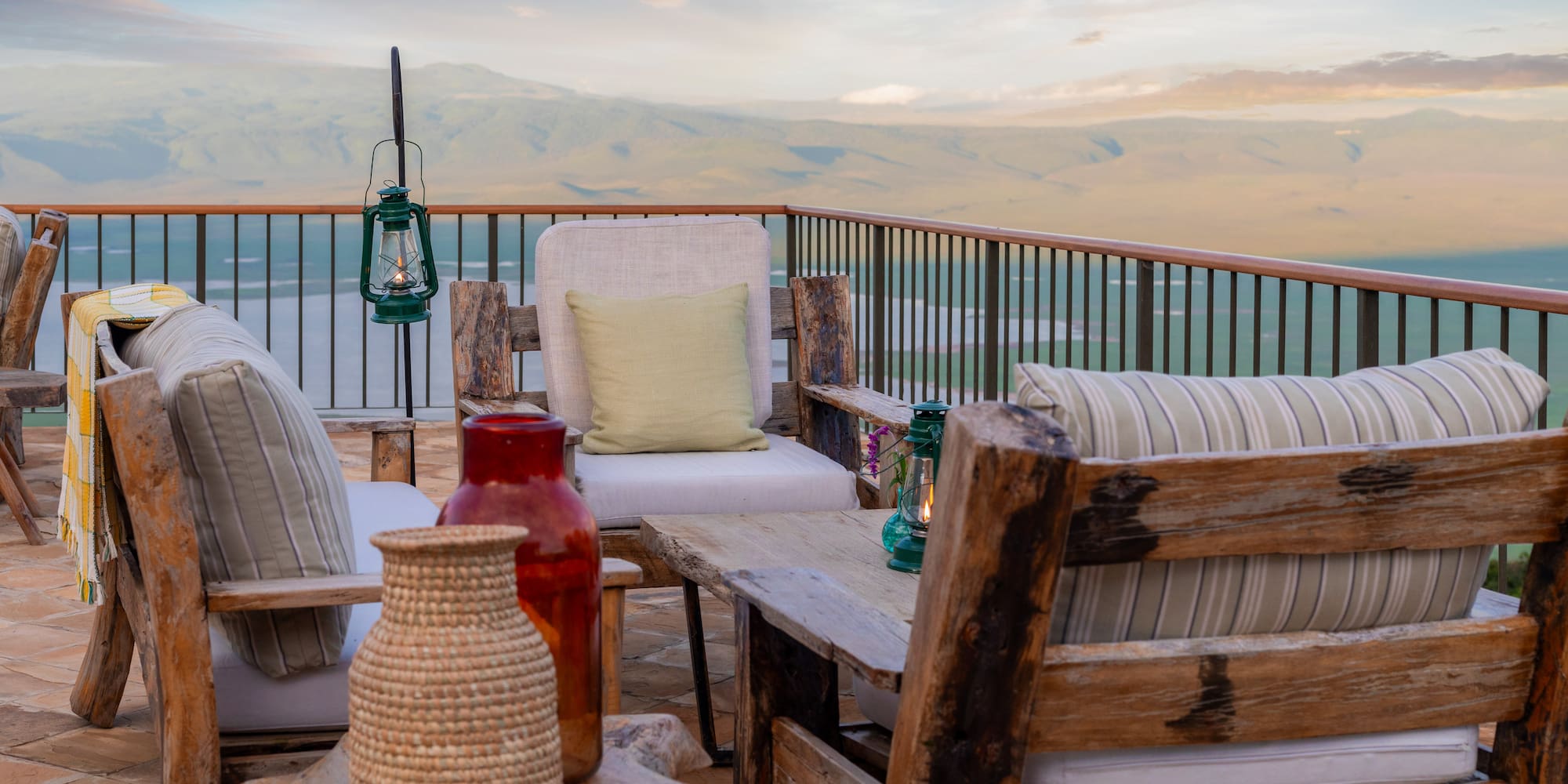 a patio with a view of mountains and a lake