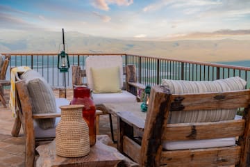 a patio with a view of mountains and a lake