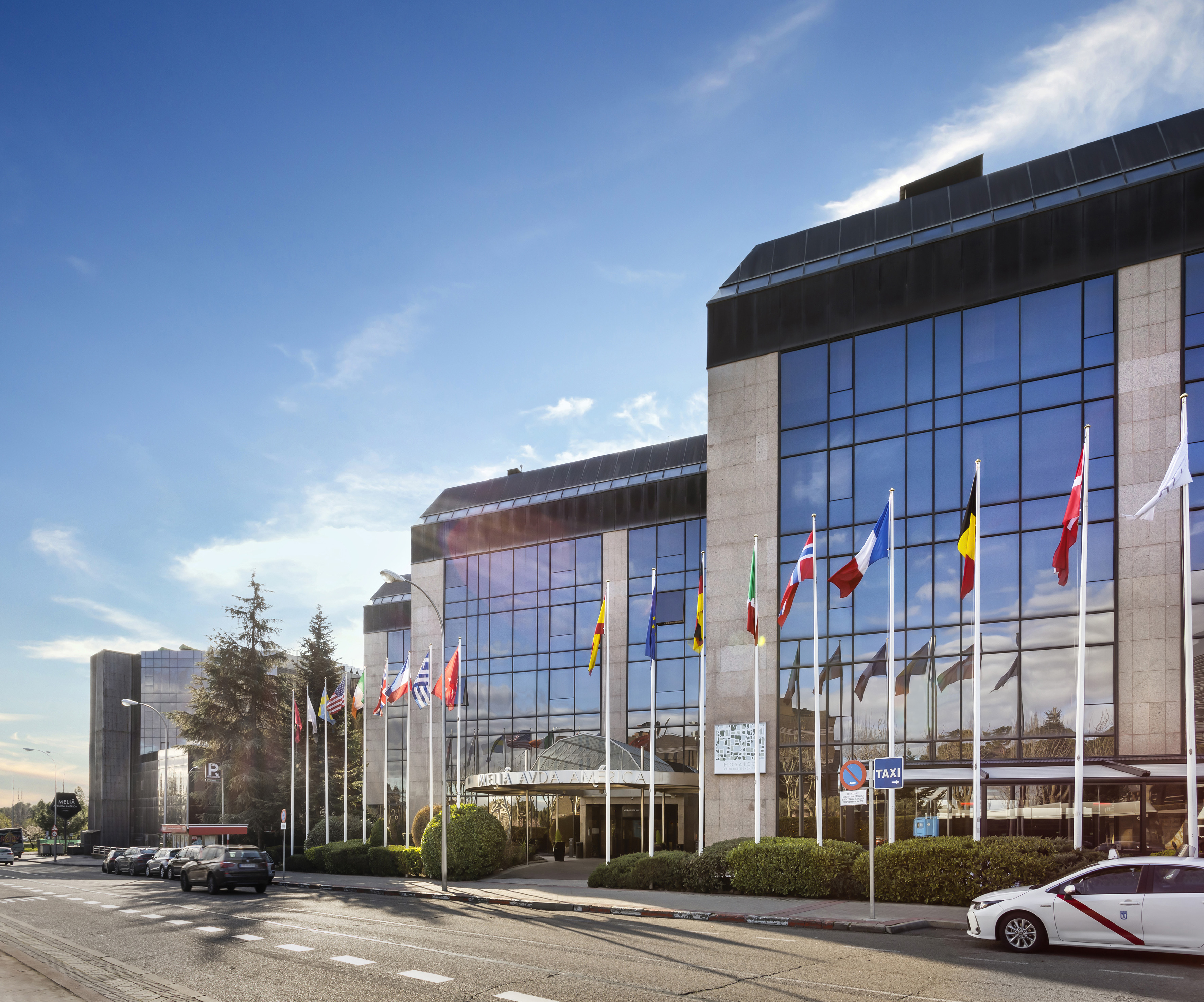 Melia Avda America hotel, modern glass building, international flags, Madrid.