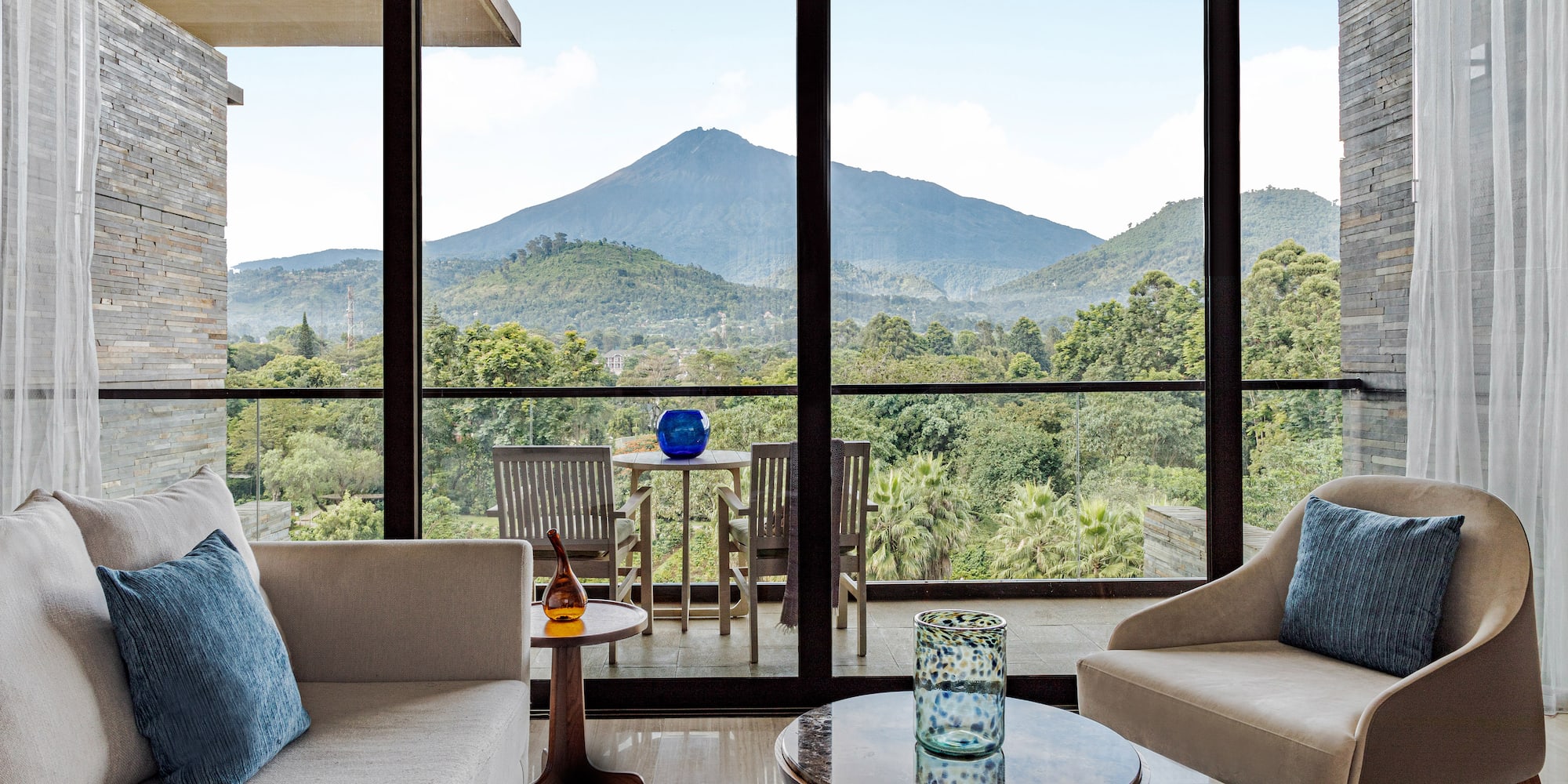 a living room with a view of mountains and trees