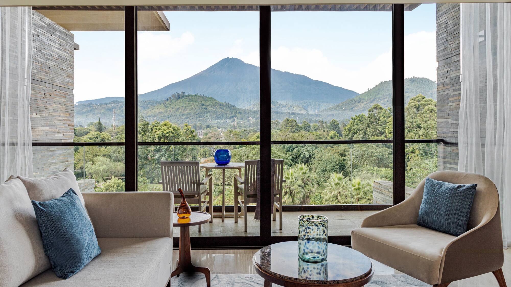 a living room with a view of mountains and trees