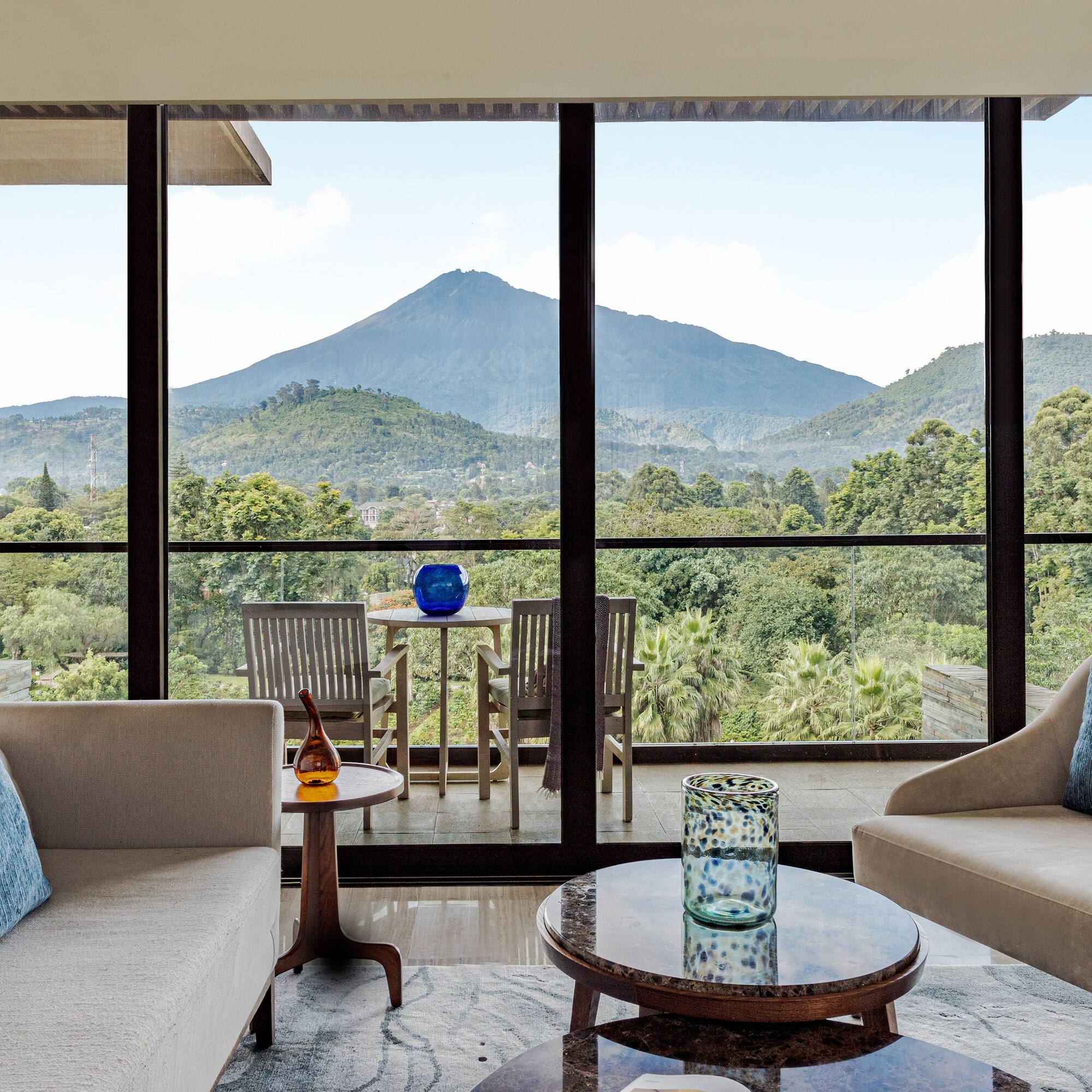 a living room with a view of mountains and trees
