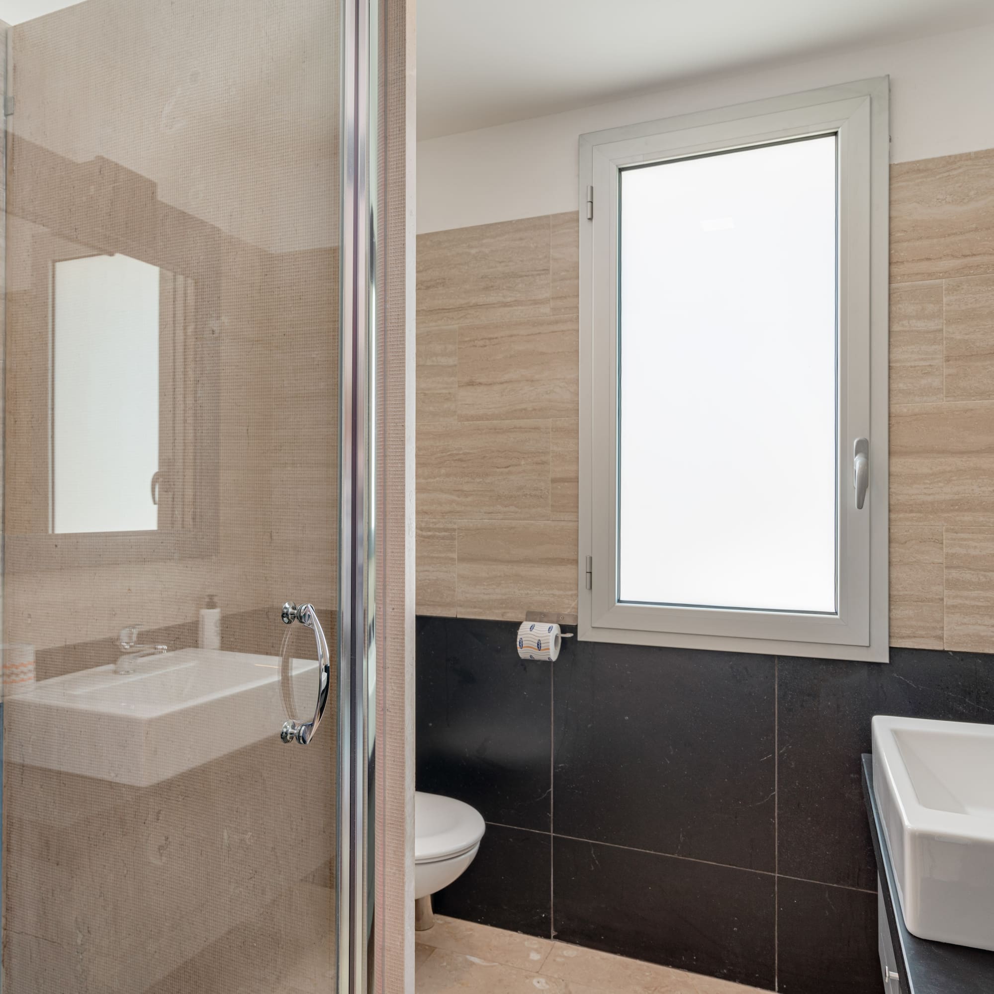 a bathroom with a glass shower door