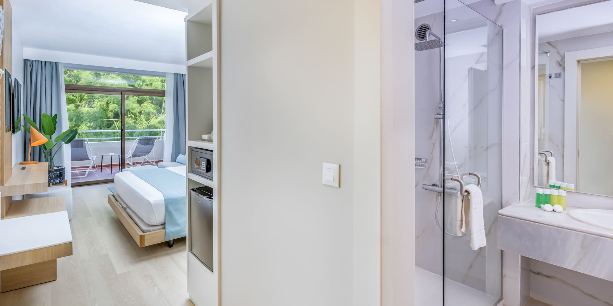 a bathroom with a bed and a glass shower