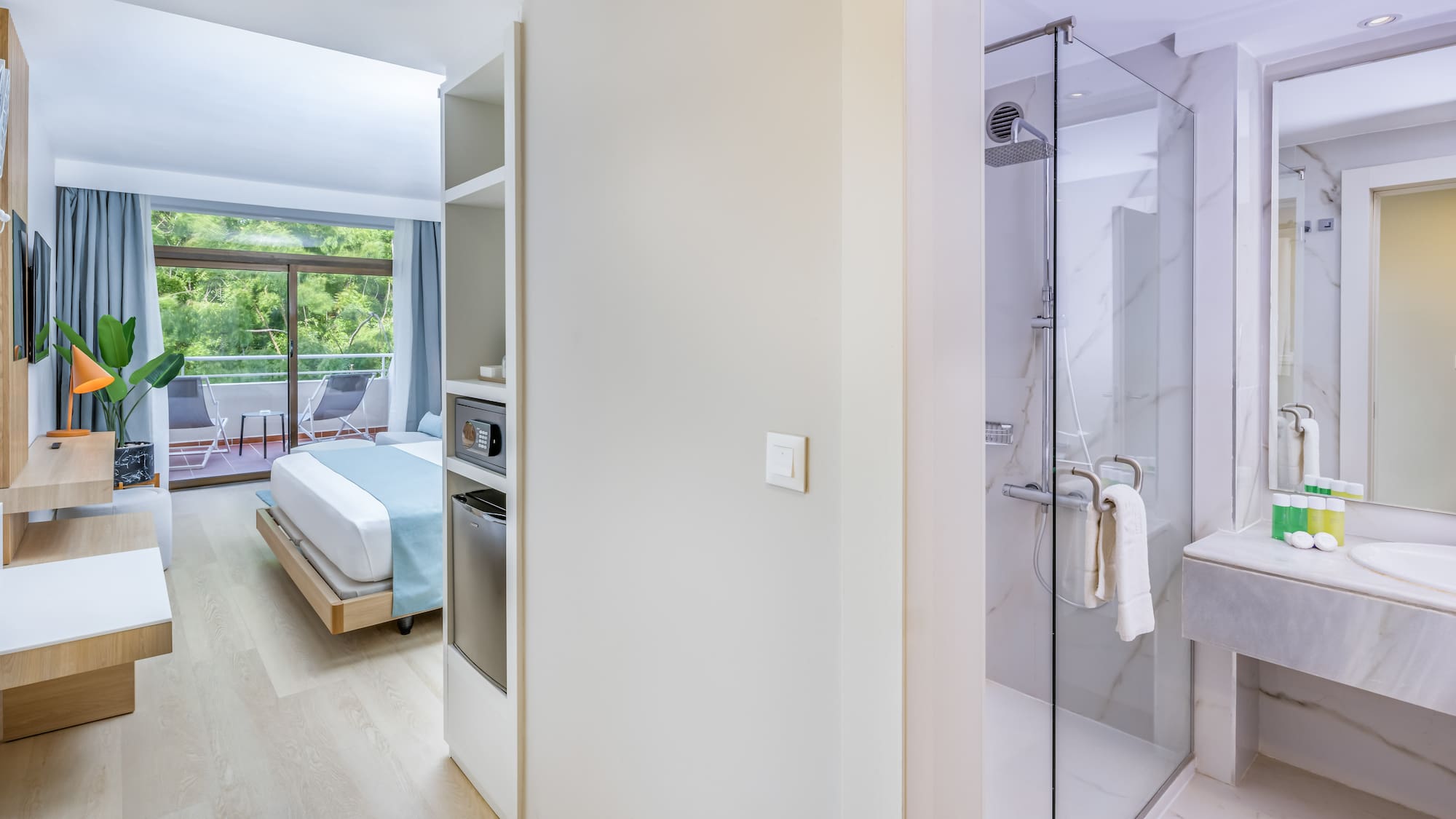 a bathroom with a bed and a glass shower