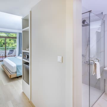 a bathroom with a bed and a glass shower