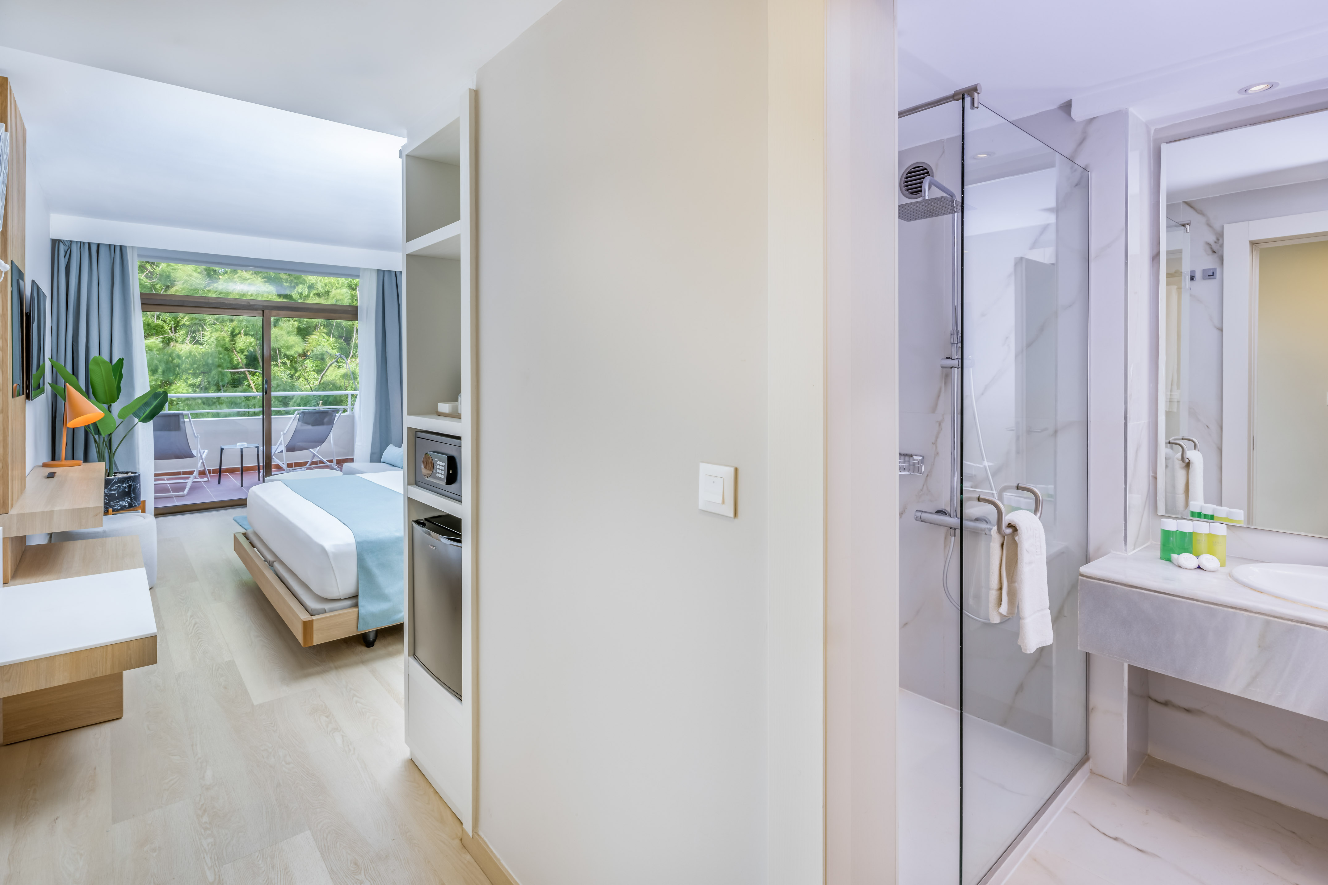 a bathroom with a bed and a glass shower