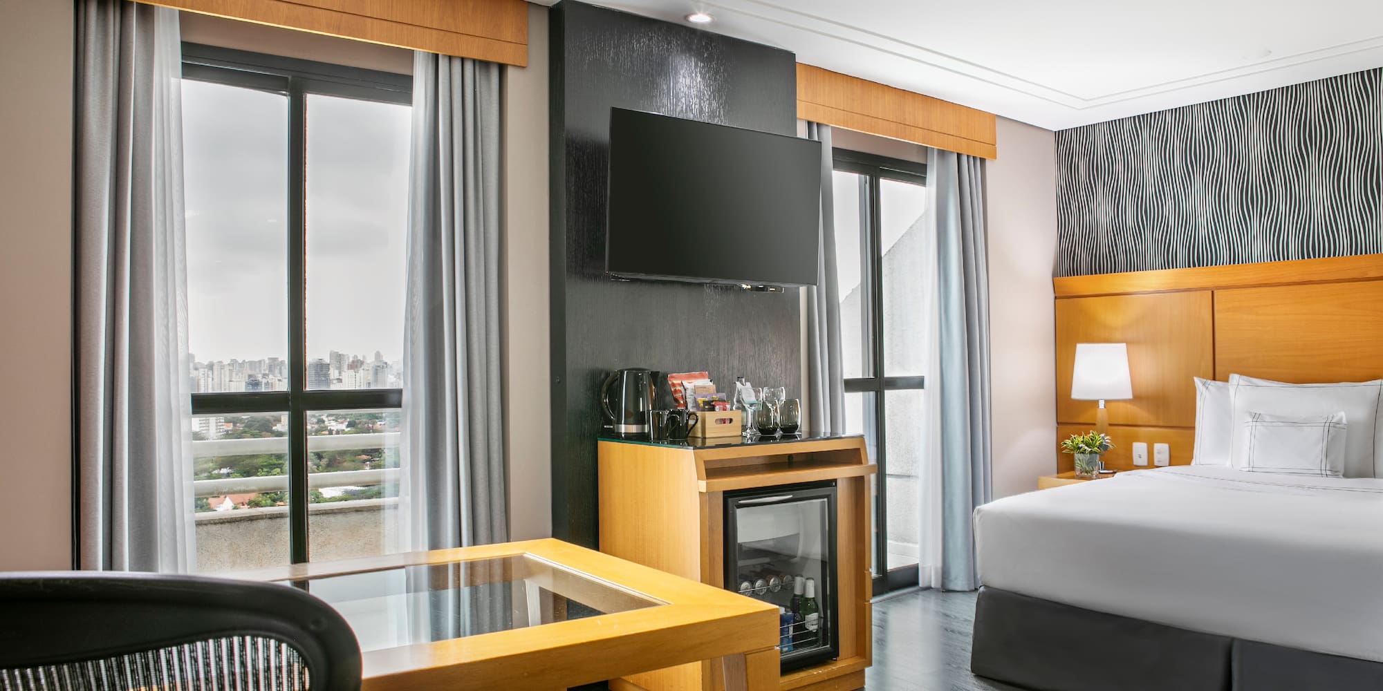 a room with a bed and a television