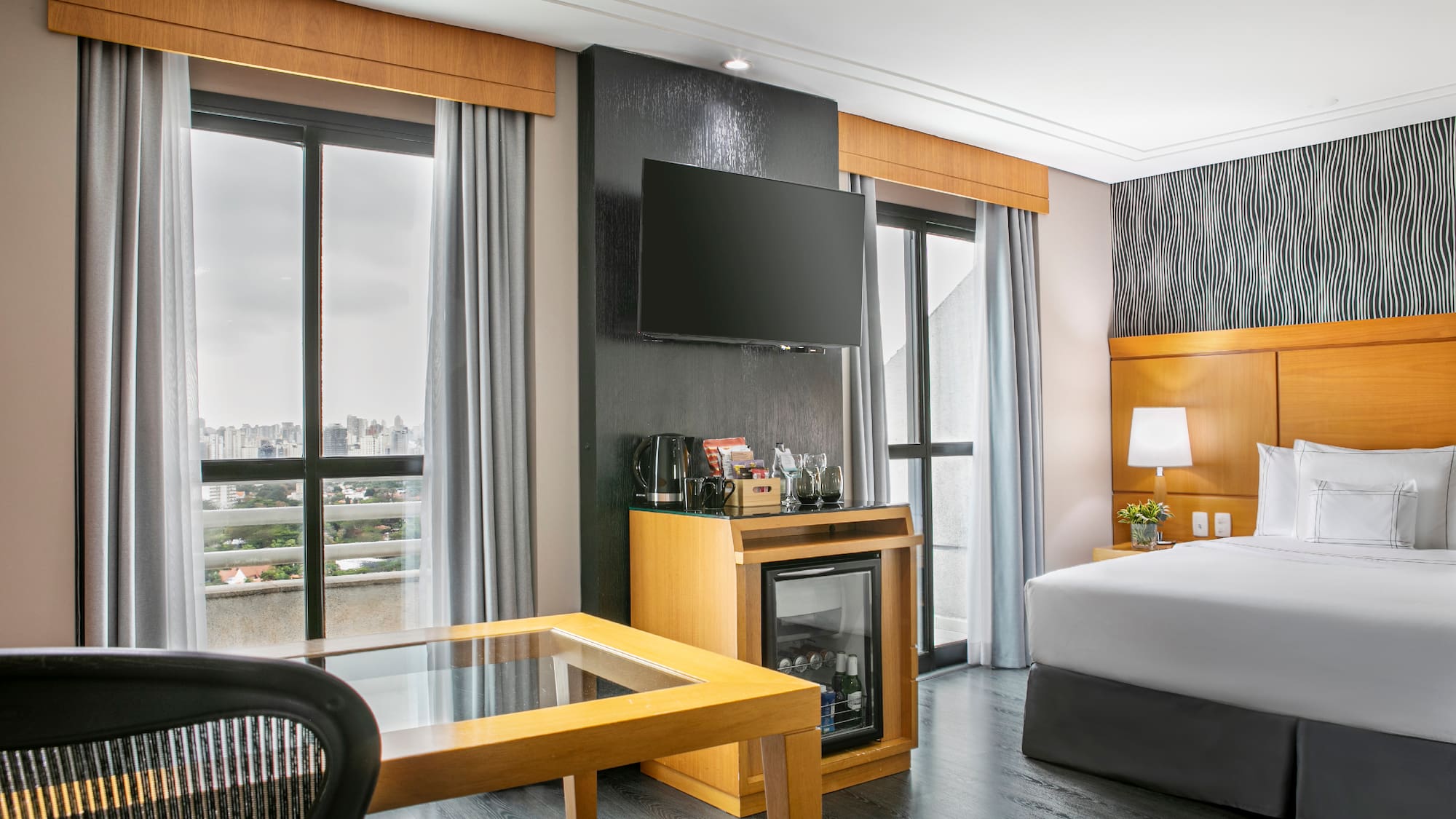 a room with a bed and a television