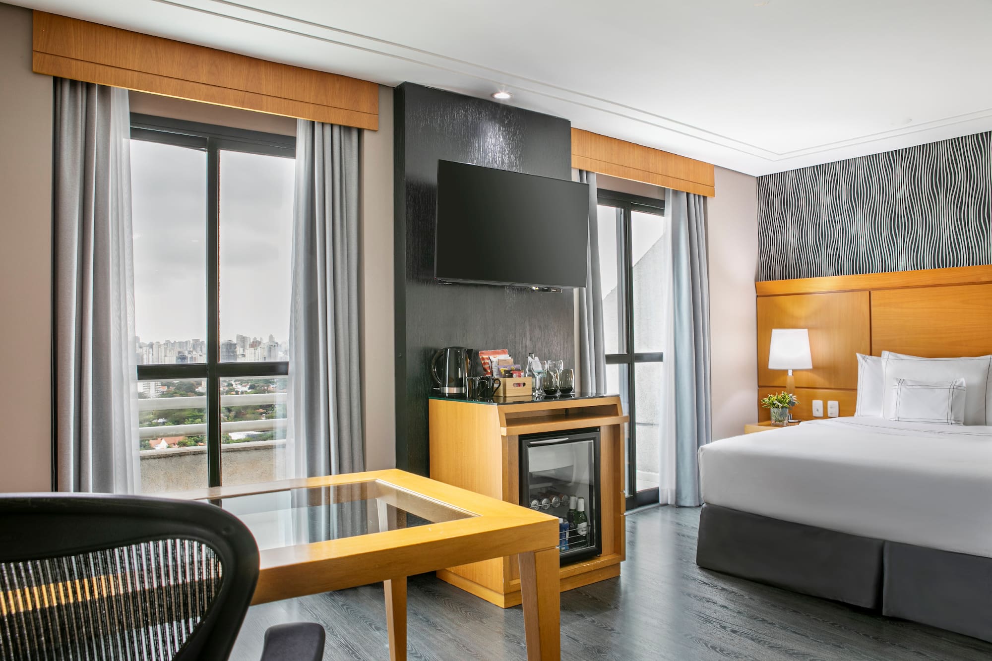 a room with a bed and a television