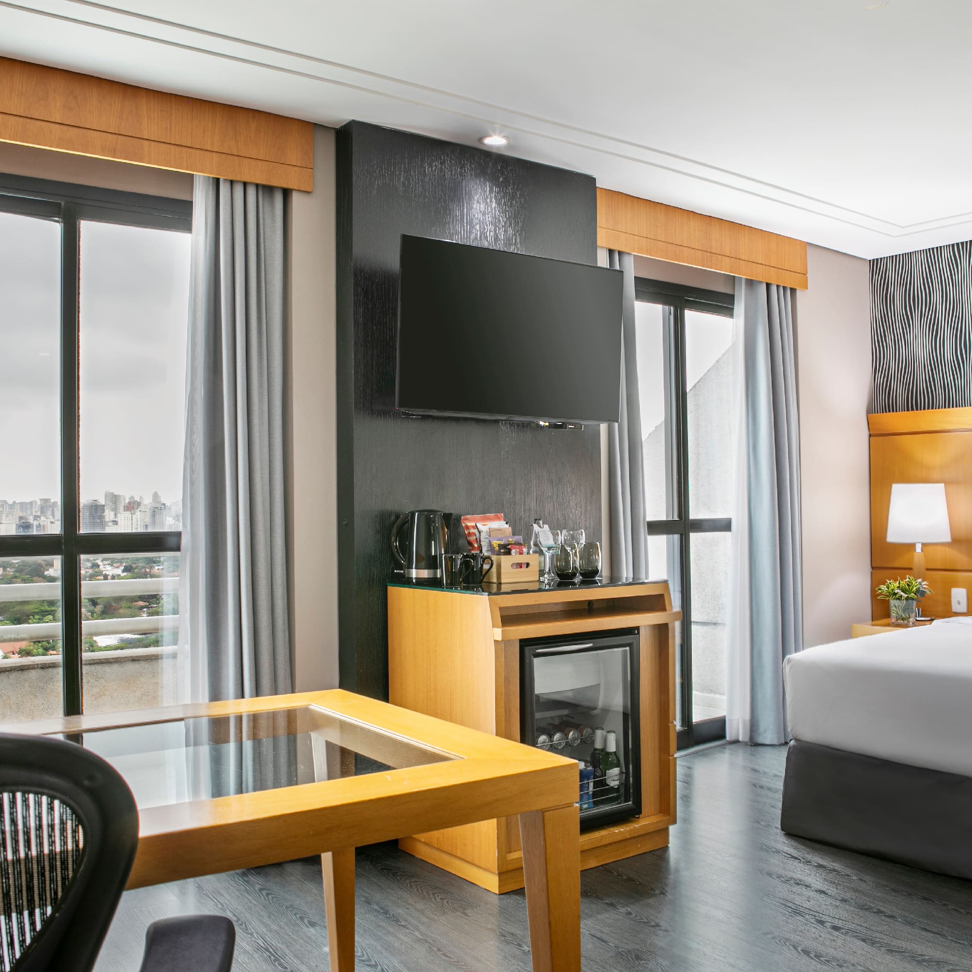 a room with a bed and a television