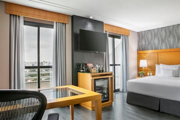 a room with a bed and a television