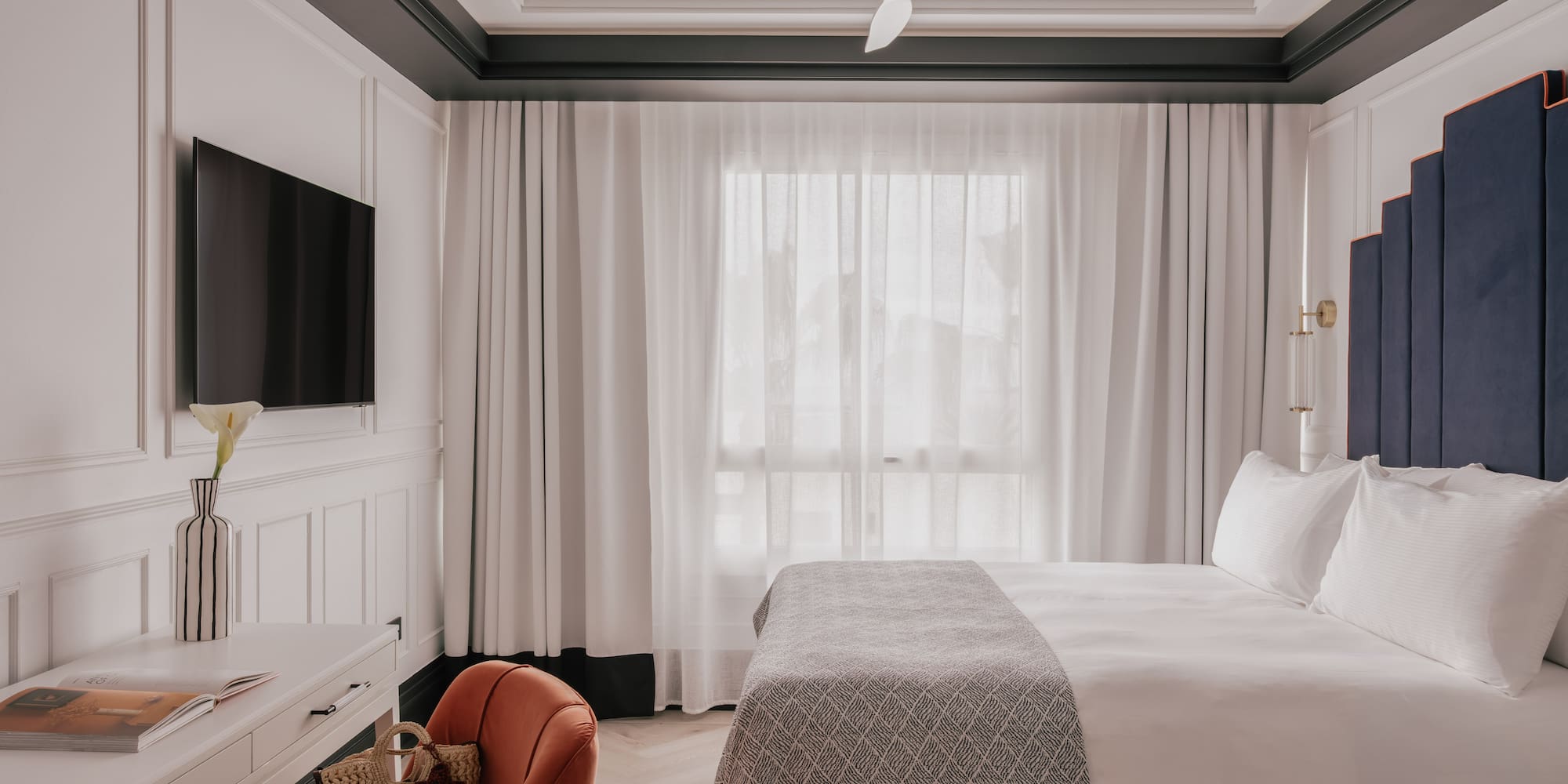 a room with a bed and a television