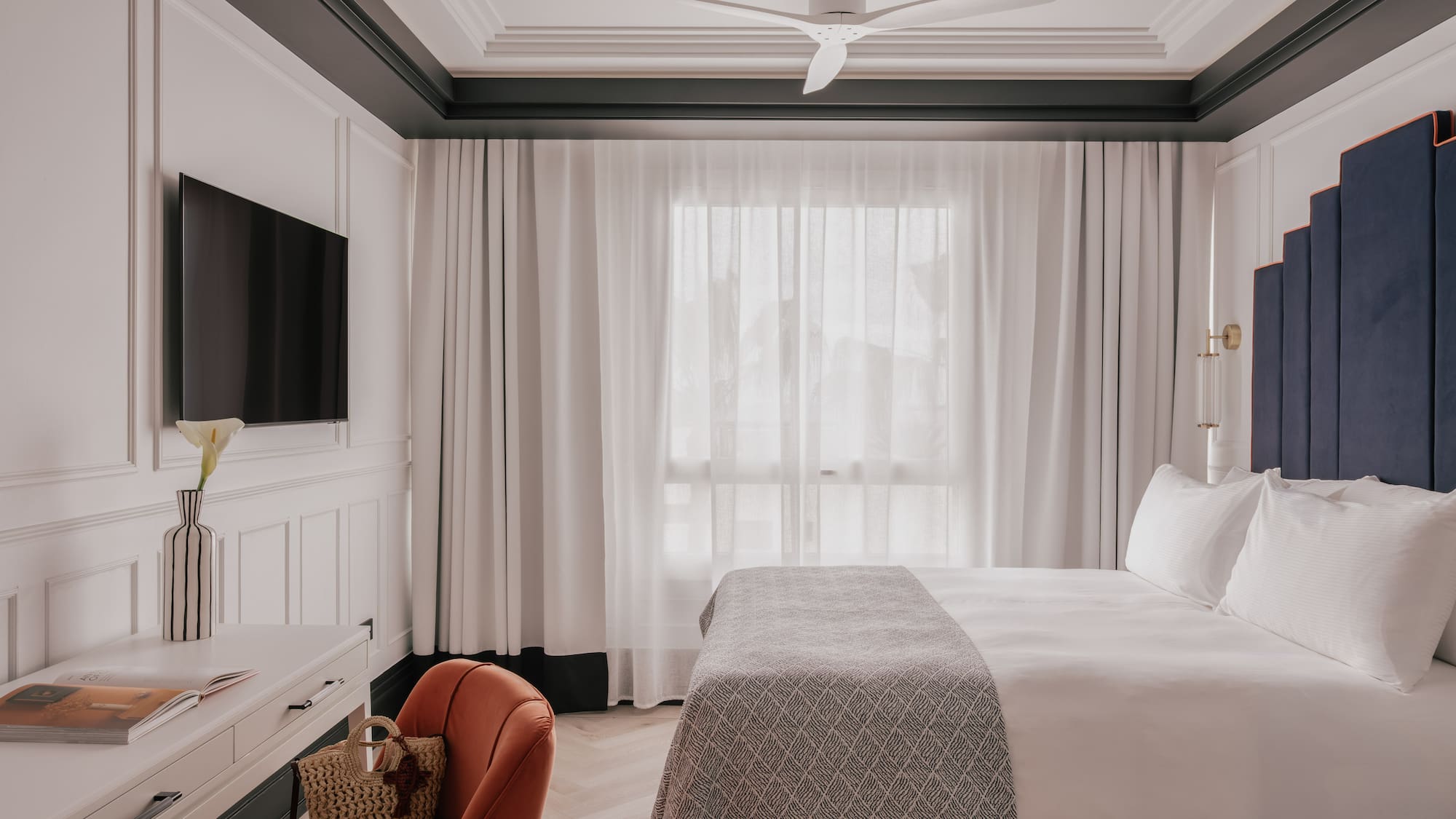 a room with a bed and a television