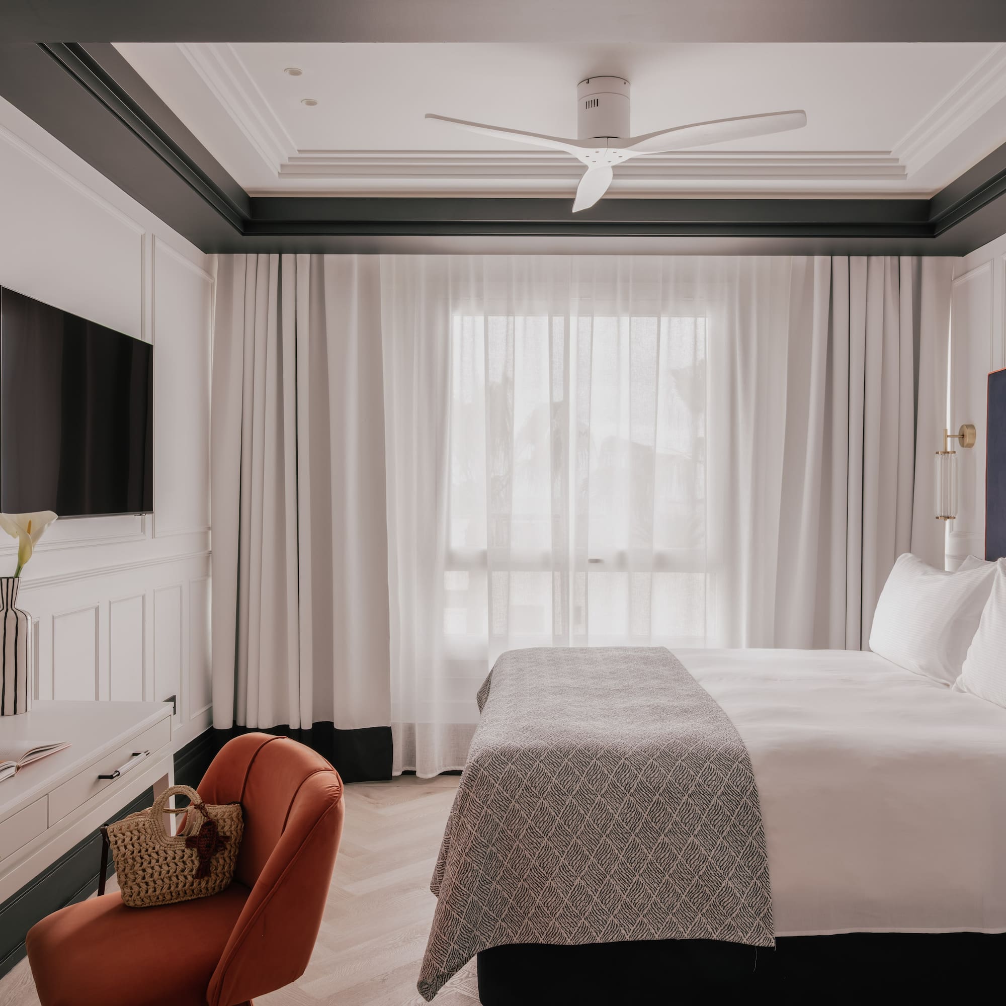 a room with a bed and a television