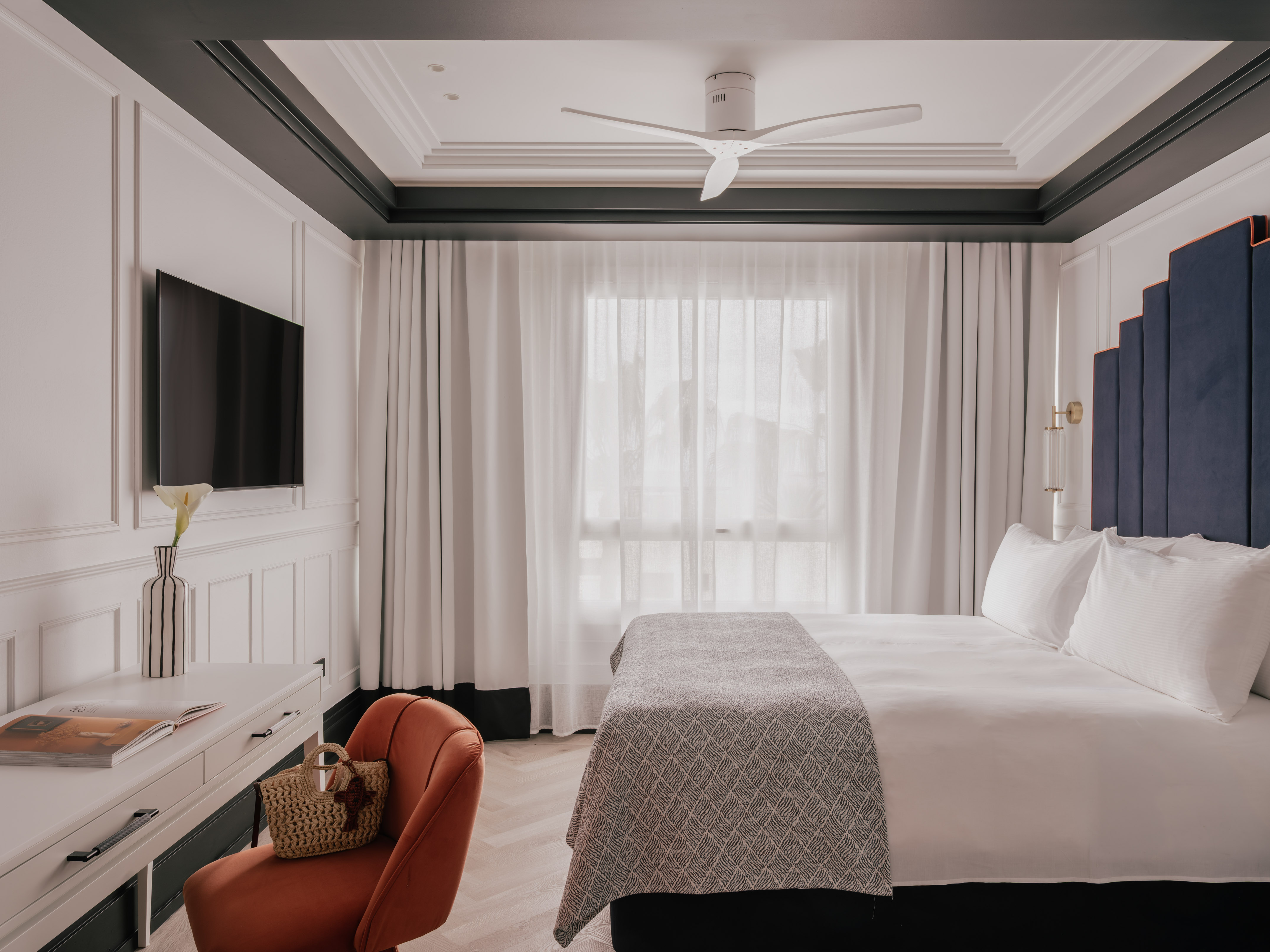 a room with a bed and a television