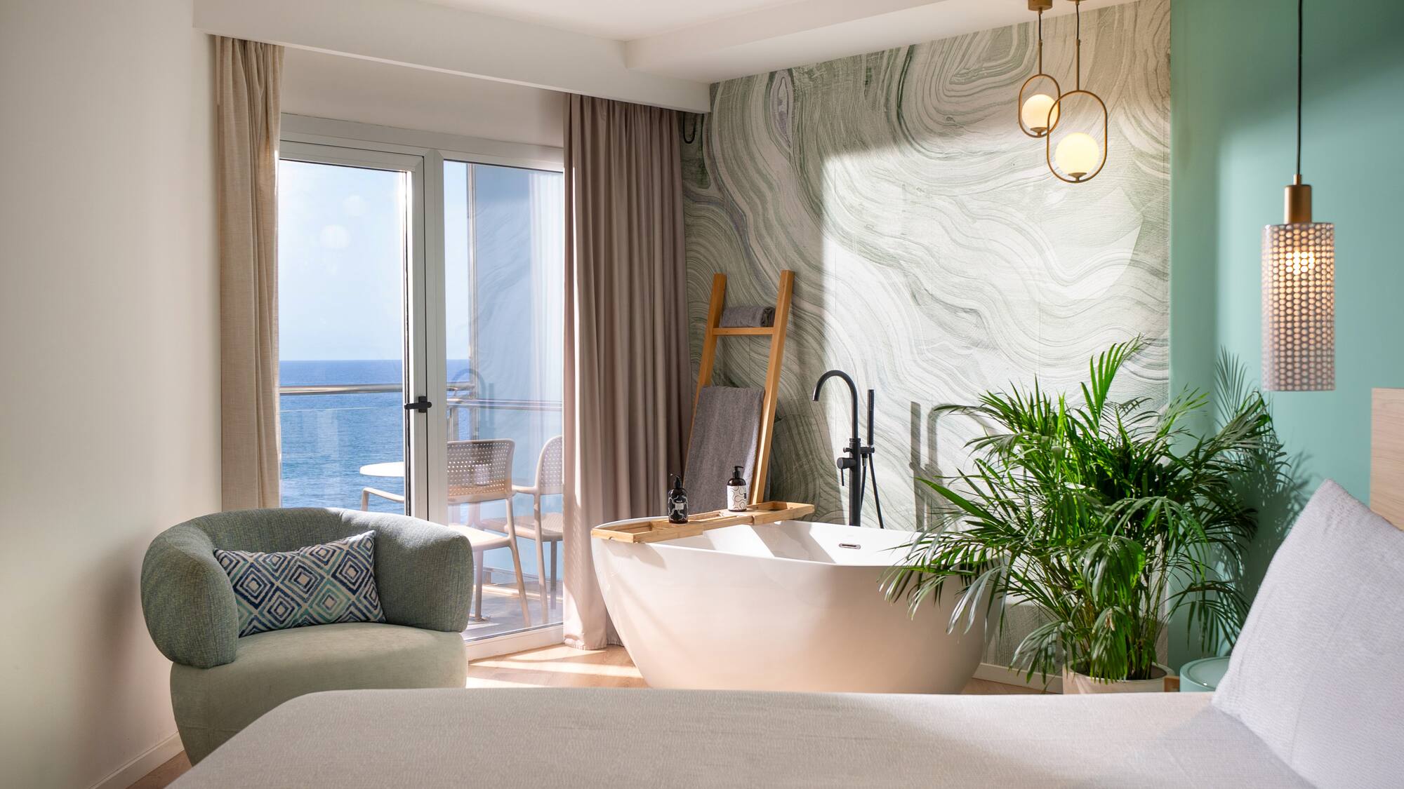 a room with a tub and a bed and a window