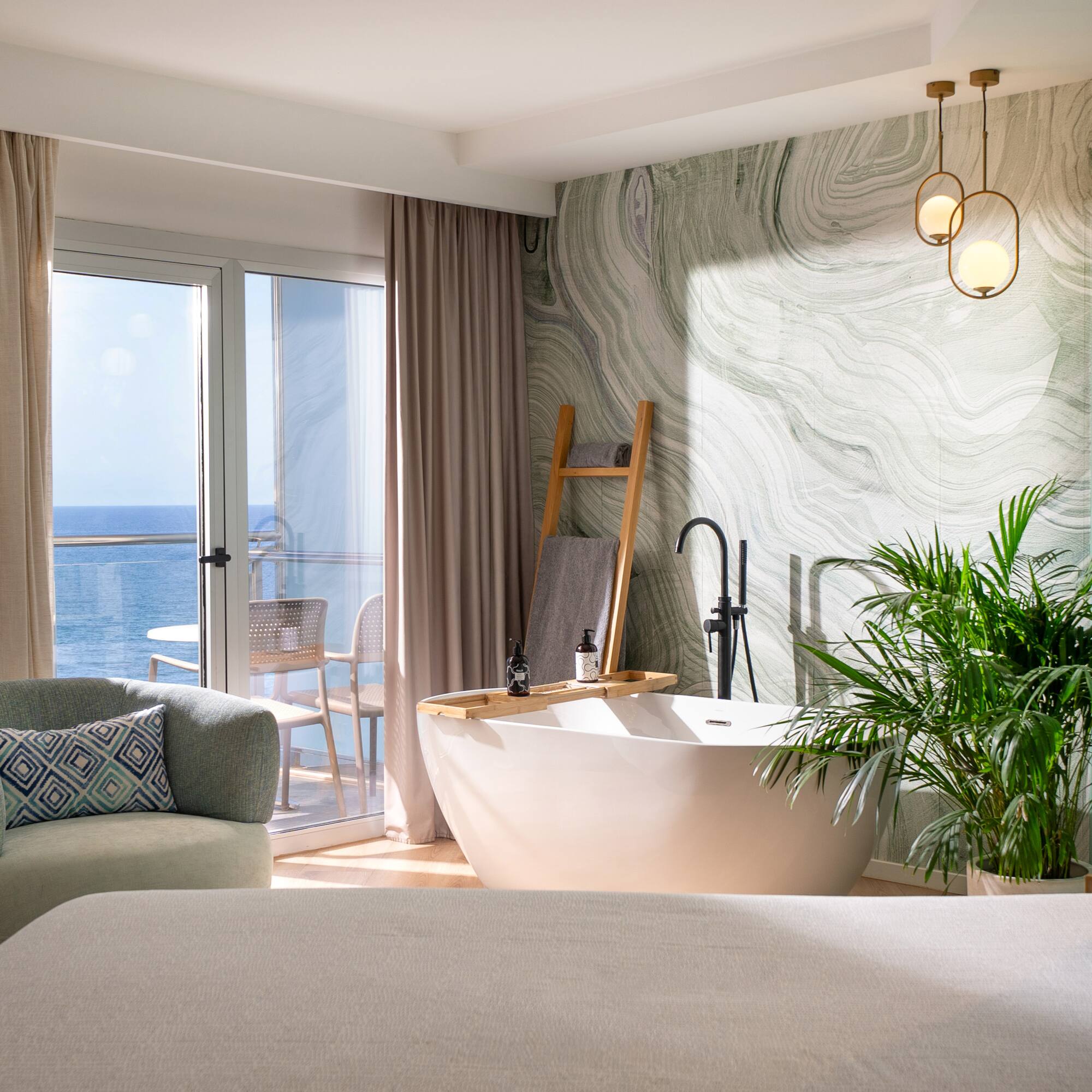 a room with a tub and a bed and a window