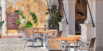 a table and chairs outside of a building
