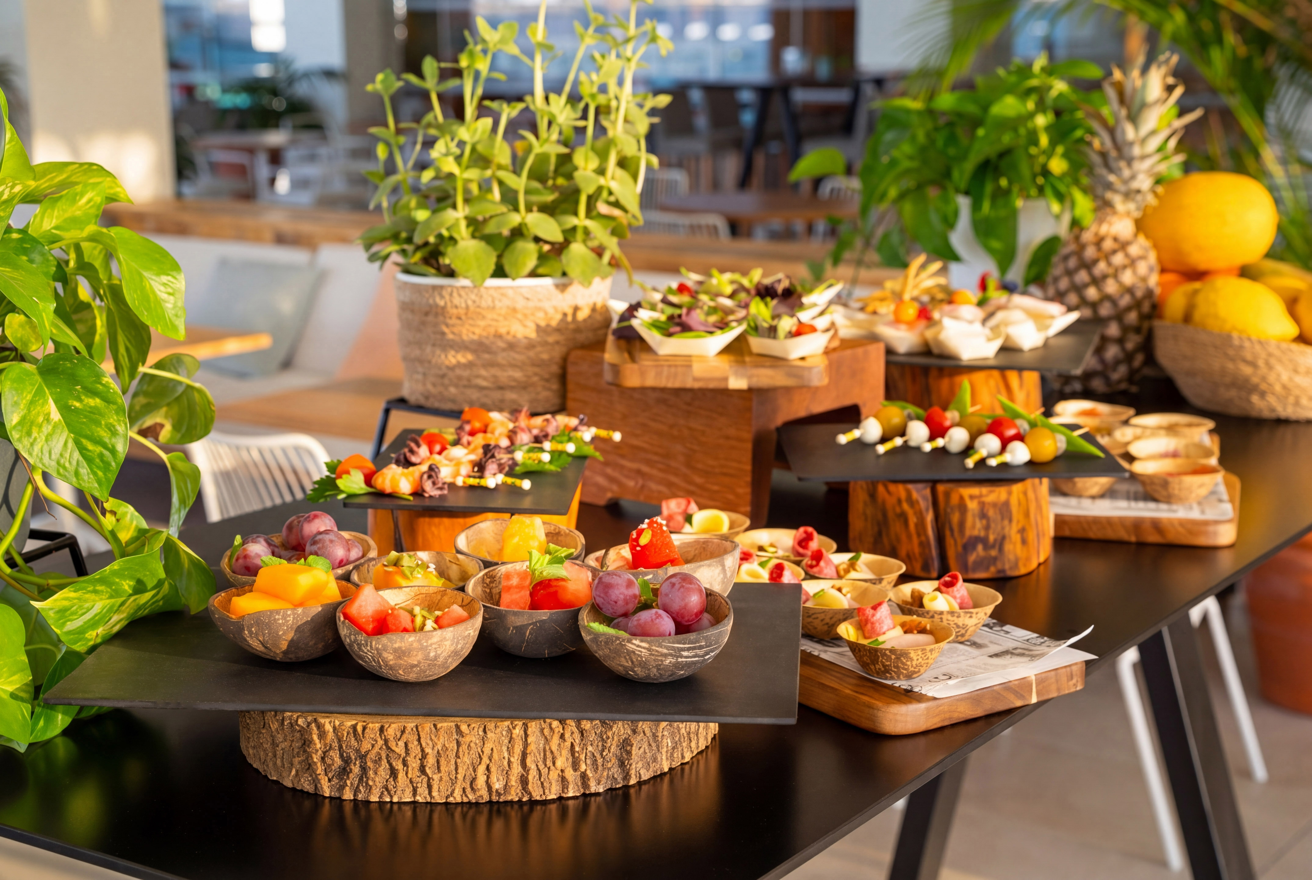 Mesa de buffet tropical con aperitivos, ensaladas y frutas frescas.