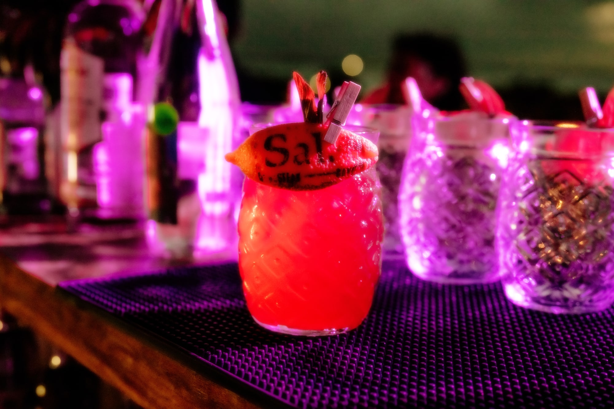 a glass with a drink on a table