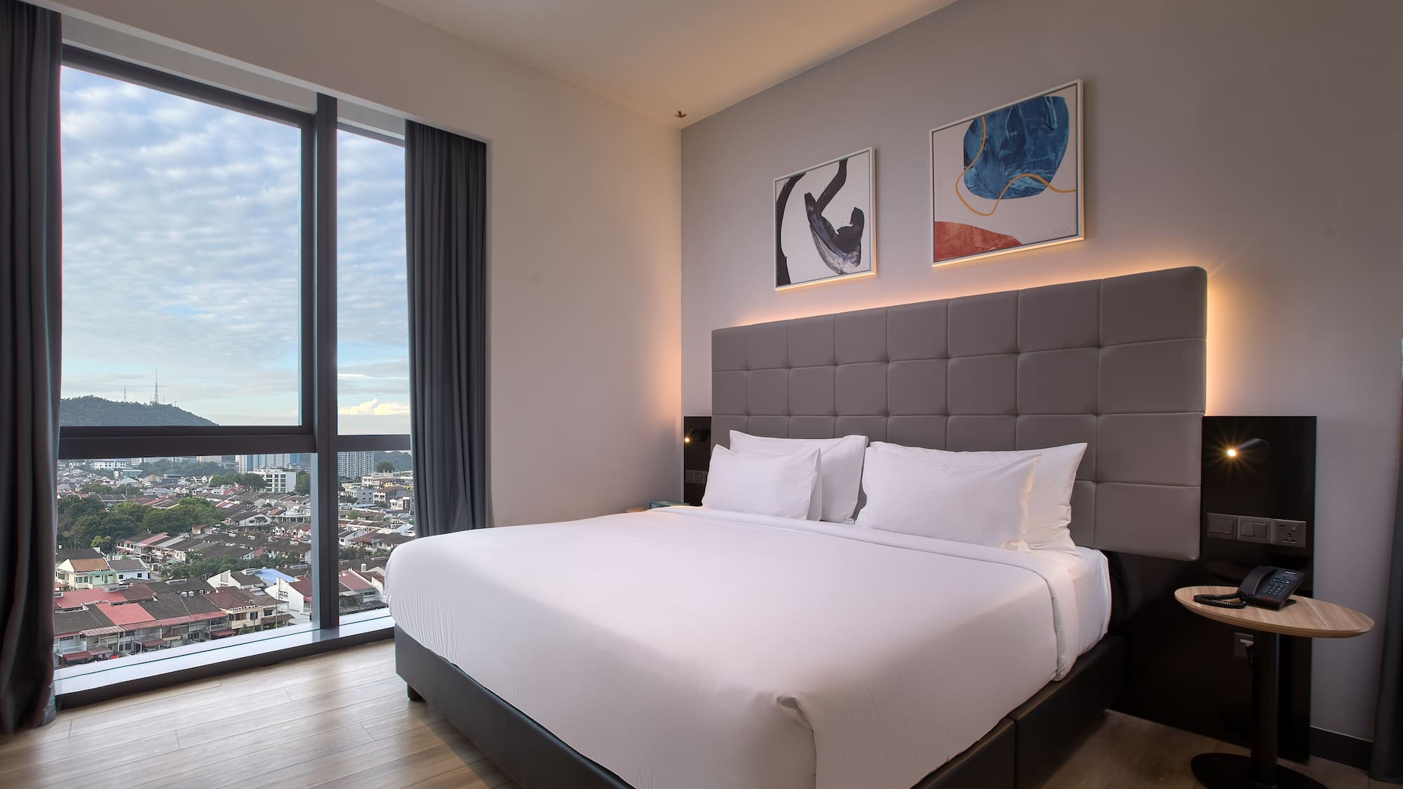 a bed in a room with a view of a city